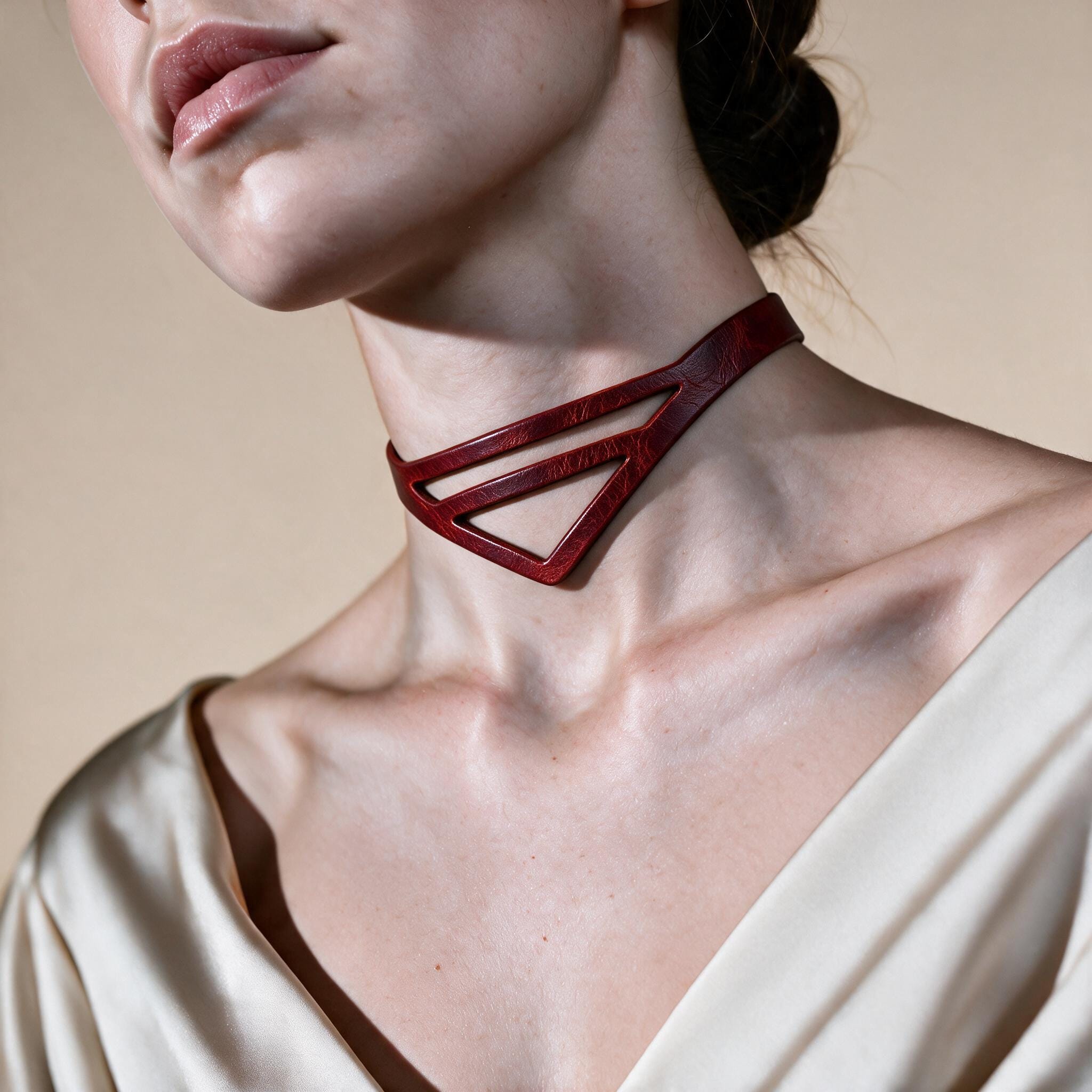 A close-up of a woman's neck and chest area wearing a red choker necklace.