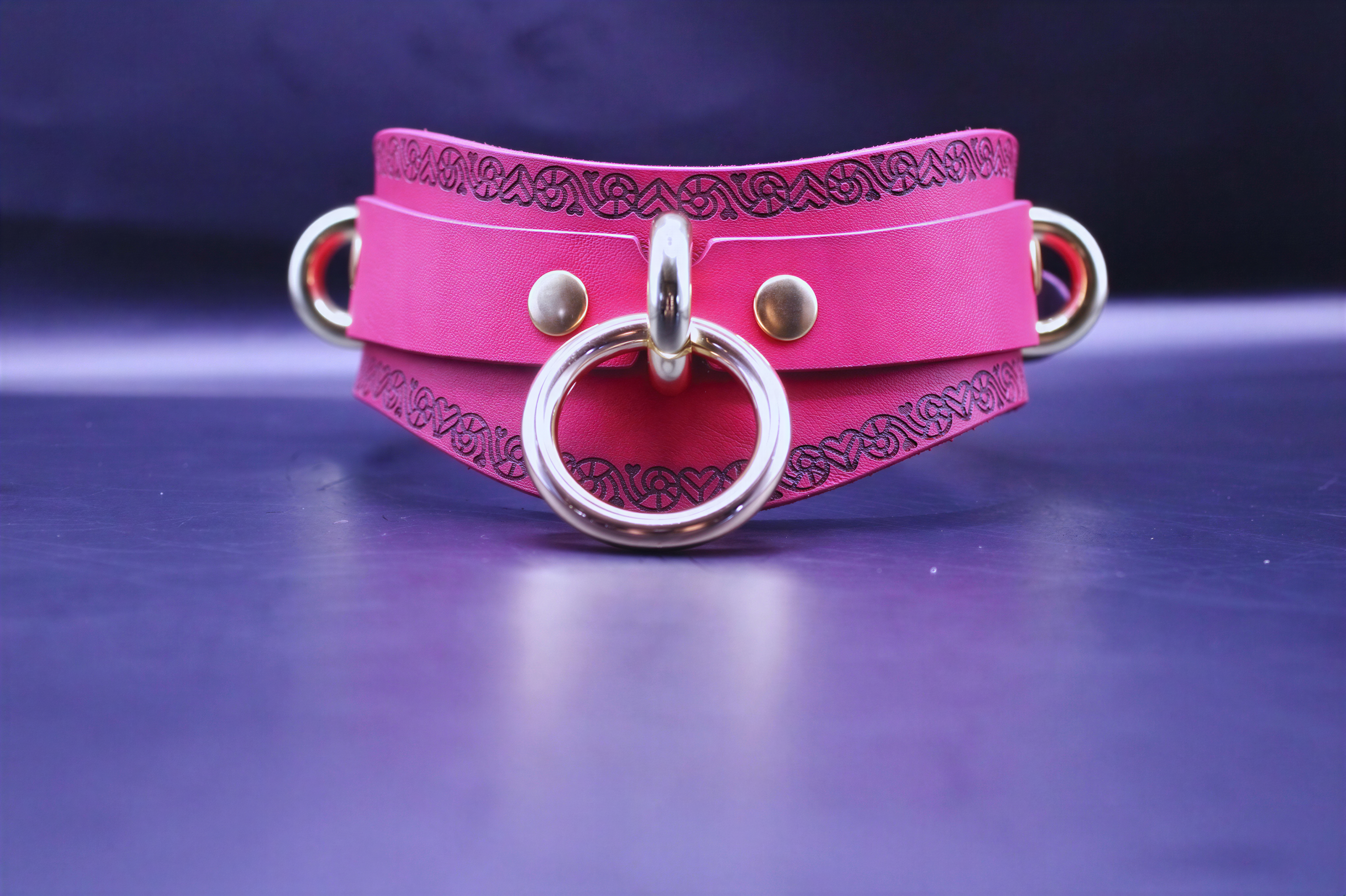 Handcrafted pink BDSM collar with O-ring, featuring a heart motif, perfect for submissive jewelry and BDSM accessories.