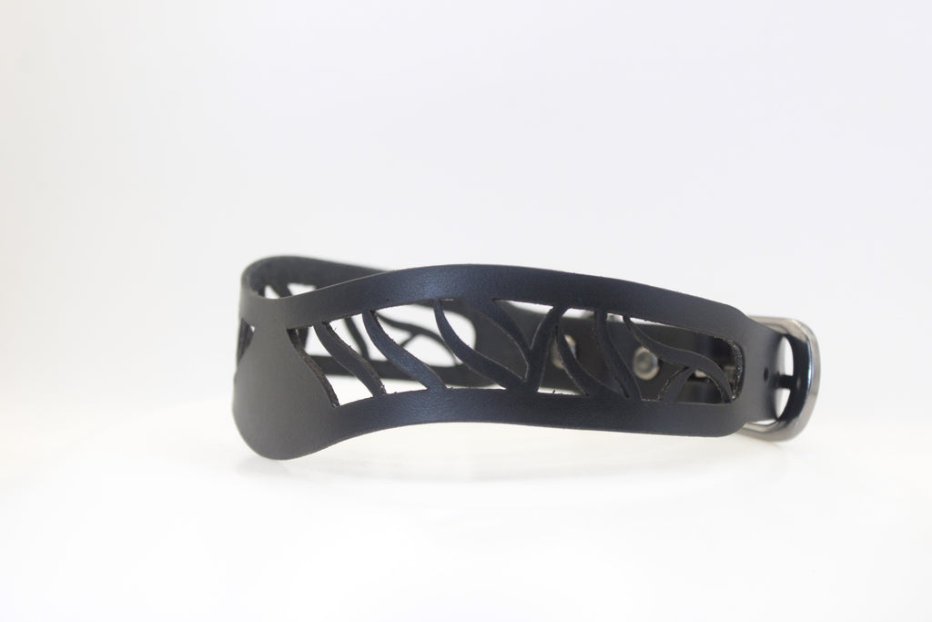 A black leather collar with a unique, intricate cutout design.
