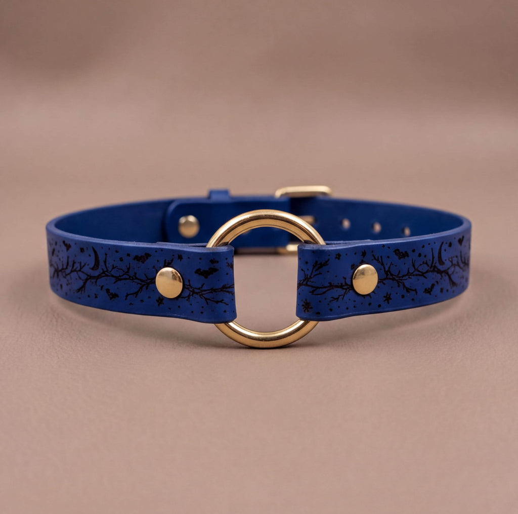 A blue leather choker collar with a gold-colored circular buckle.