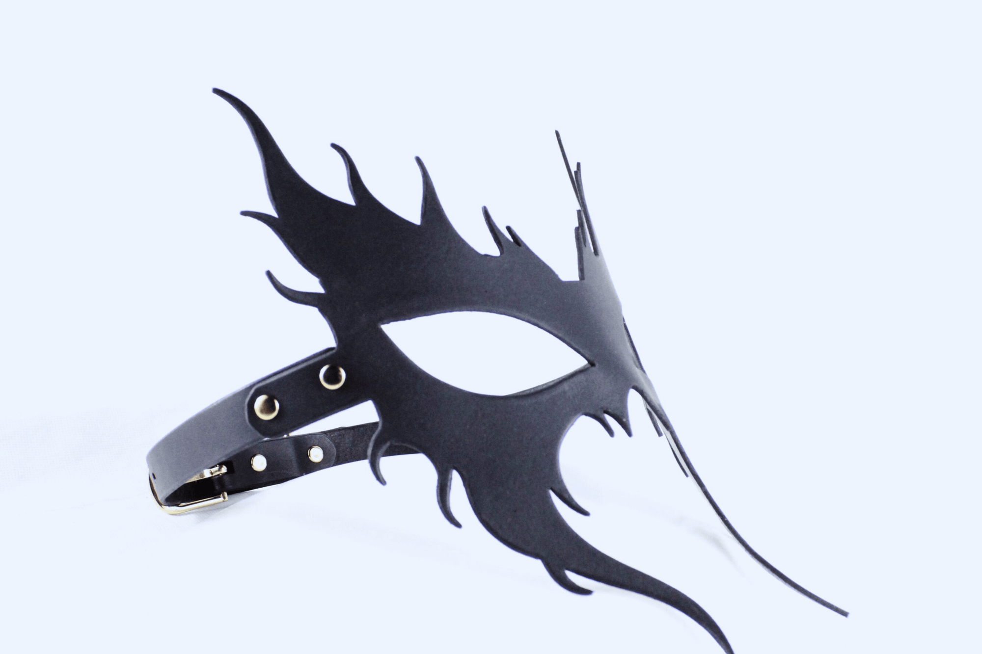 A black mask with a unique, stylized design is shown against a white background.