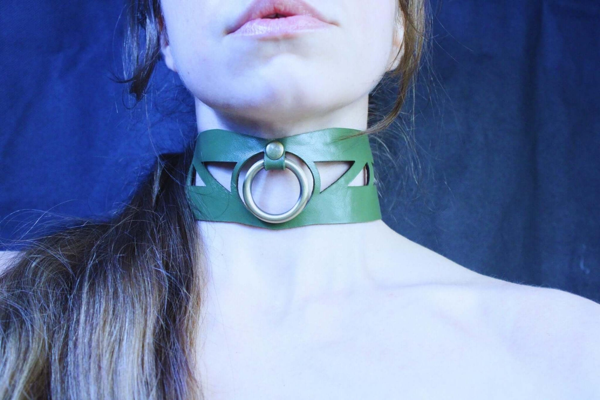 Geometric green leather choker with O-ring, perfect for BDSM, submissive jewelry, and edgy fashion aesthetics.