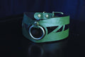 Geometric green leather choker collar with artistic cut-outs and statement O-ring, perfect for BDSM and submissive jewelry.