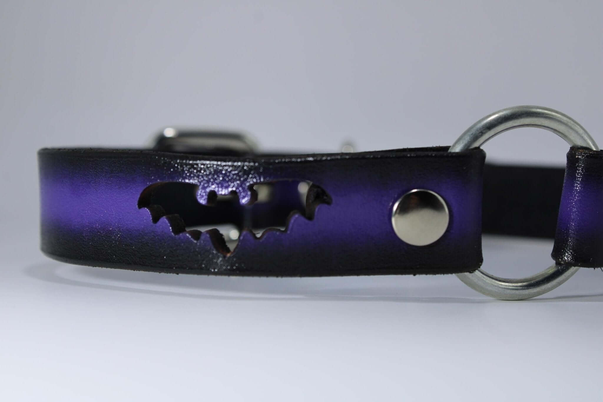 Gothic bat collar in purple leather with bat cutout and O-ring, perfect for BDSM, alternative fashion, and submissive jewelry.