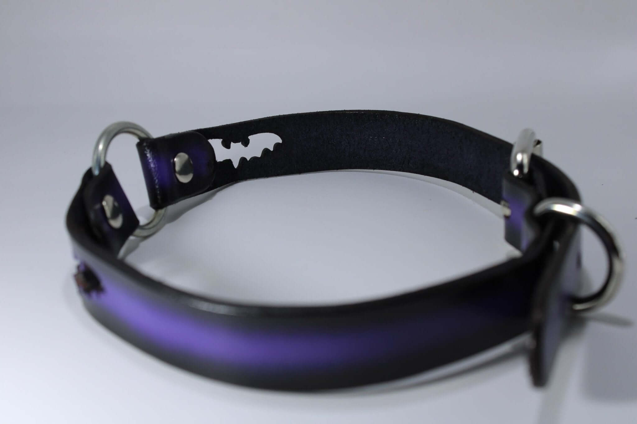 Gothic bat cutout collar in purple leather with O-rings, perfect for BDSM and alternative fashion.