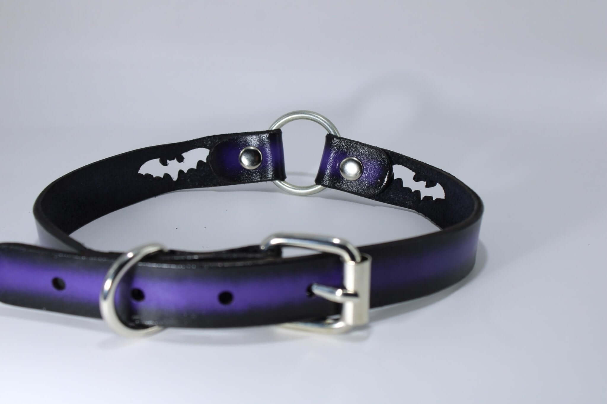 BDSM bat collar with purple leather, featuring bat cutouts and O-ring, perfect for gothic fashion and bondage play.