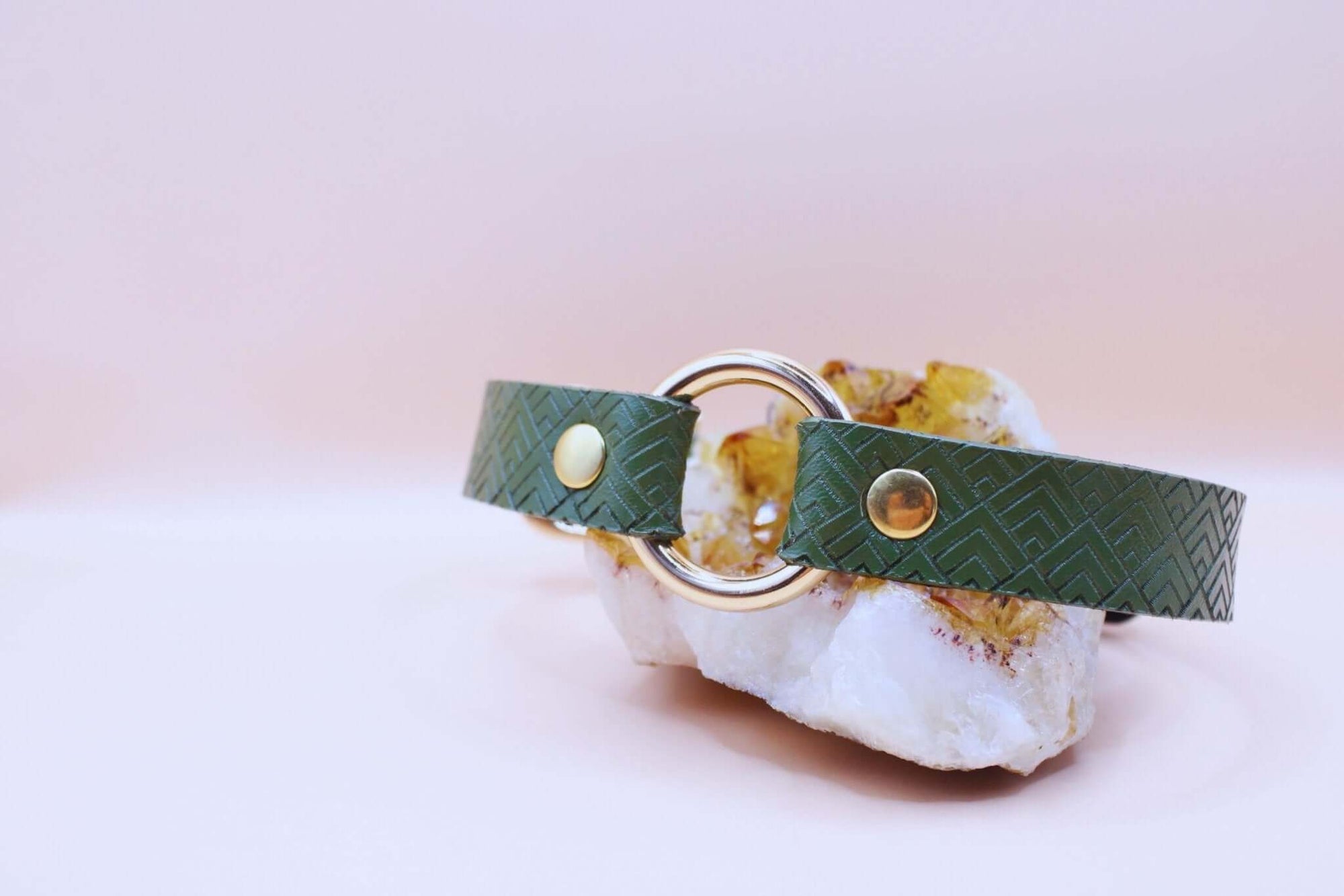 Green geometric O-ring leather collar designed for submissive jewelry and BDSM fashion, perfect as a discreet day collar.