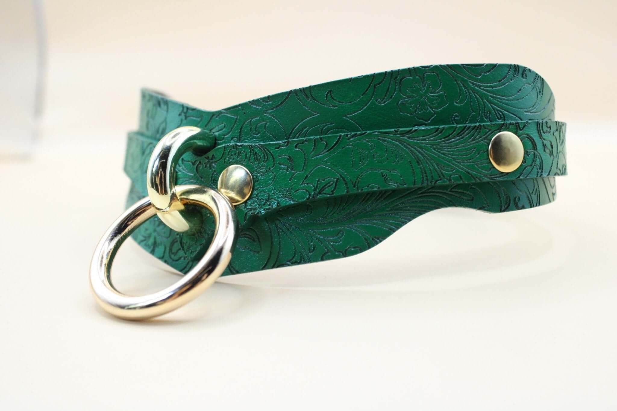Handcrafted green posture collar, embellished leather choker with floral patterns for BDSM fashion and discreet day wear.