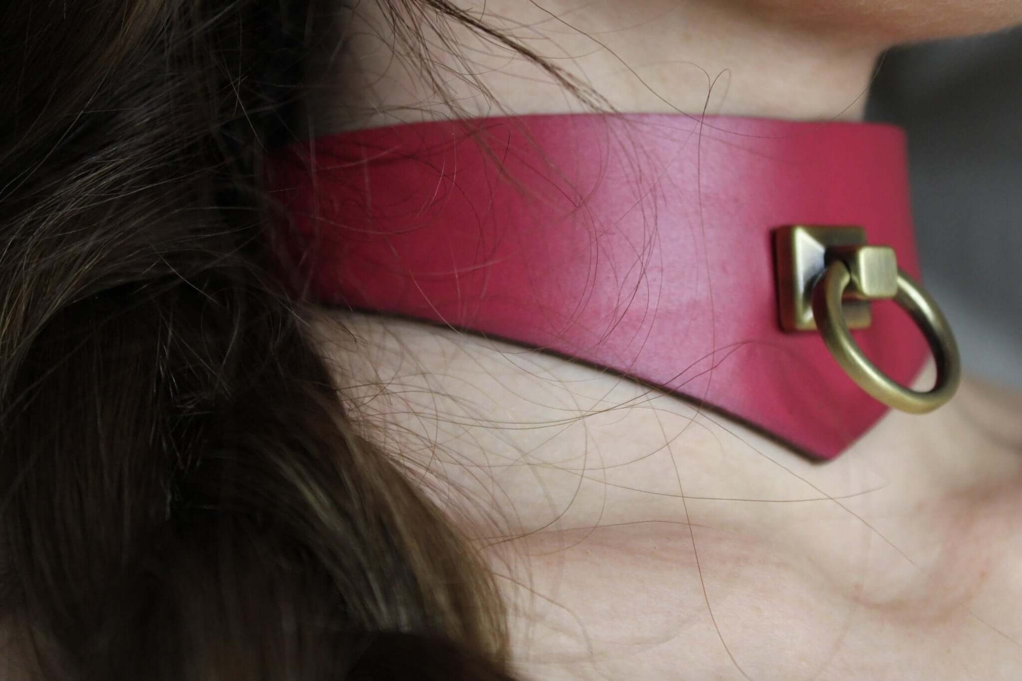 Handcrafted red leather sub collar with a gold ring, perfect for BDSM and bondage gear, ideal for discreet day wear.