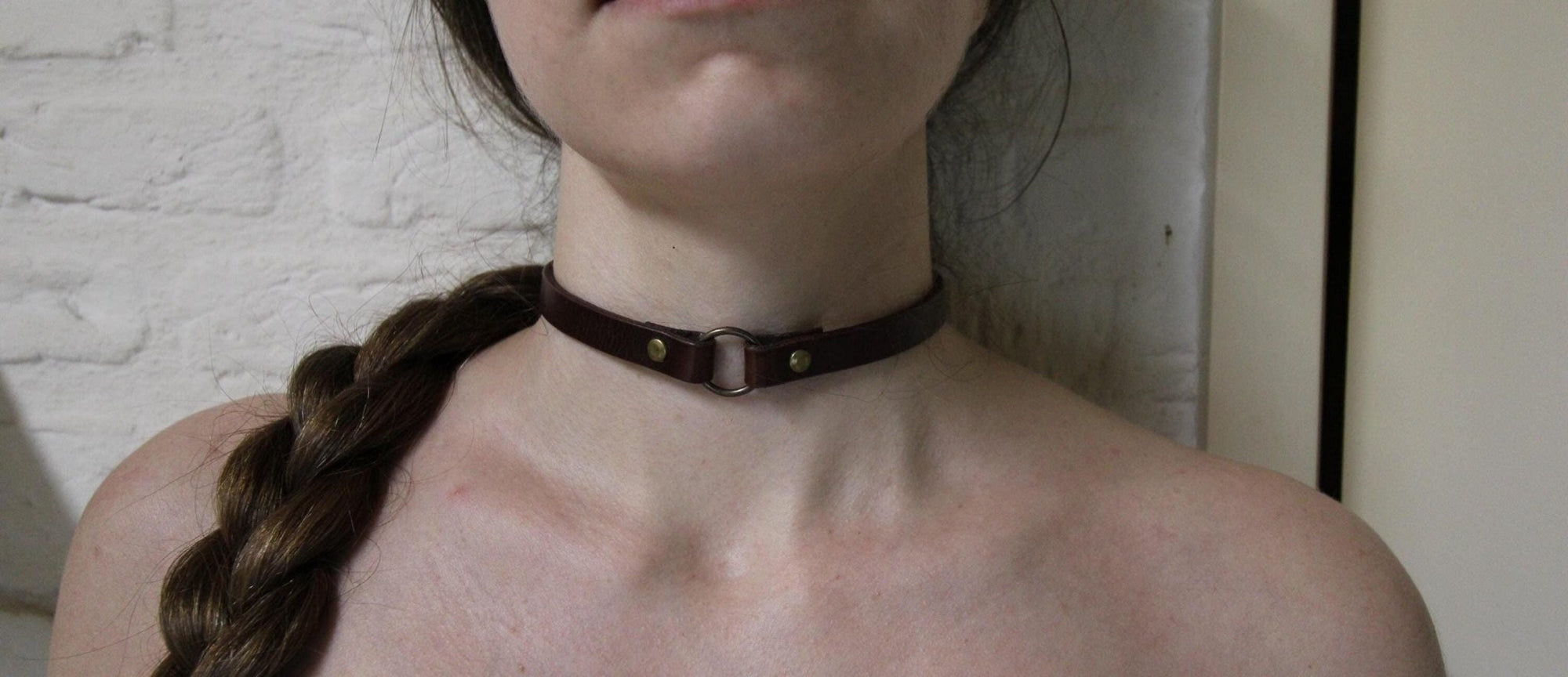 Handcrafted leather O-ring choker collar for alternative fashion, perfect for submissive and gothic styles.