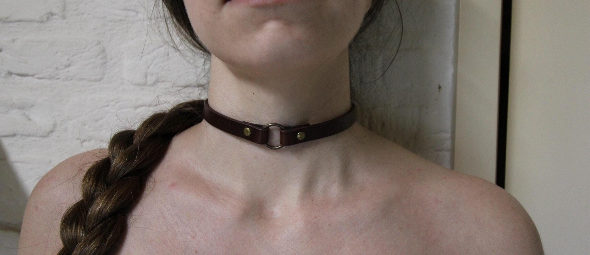 Handcrafted leather O-ring choker collar for alternative fashion, perfect for submissive and gothic styles.