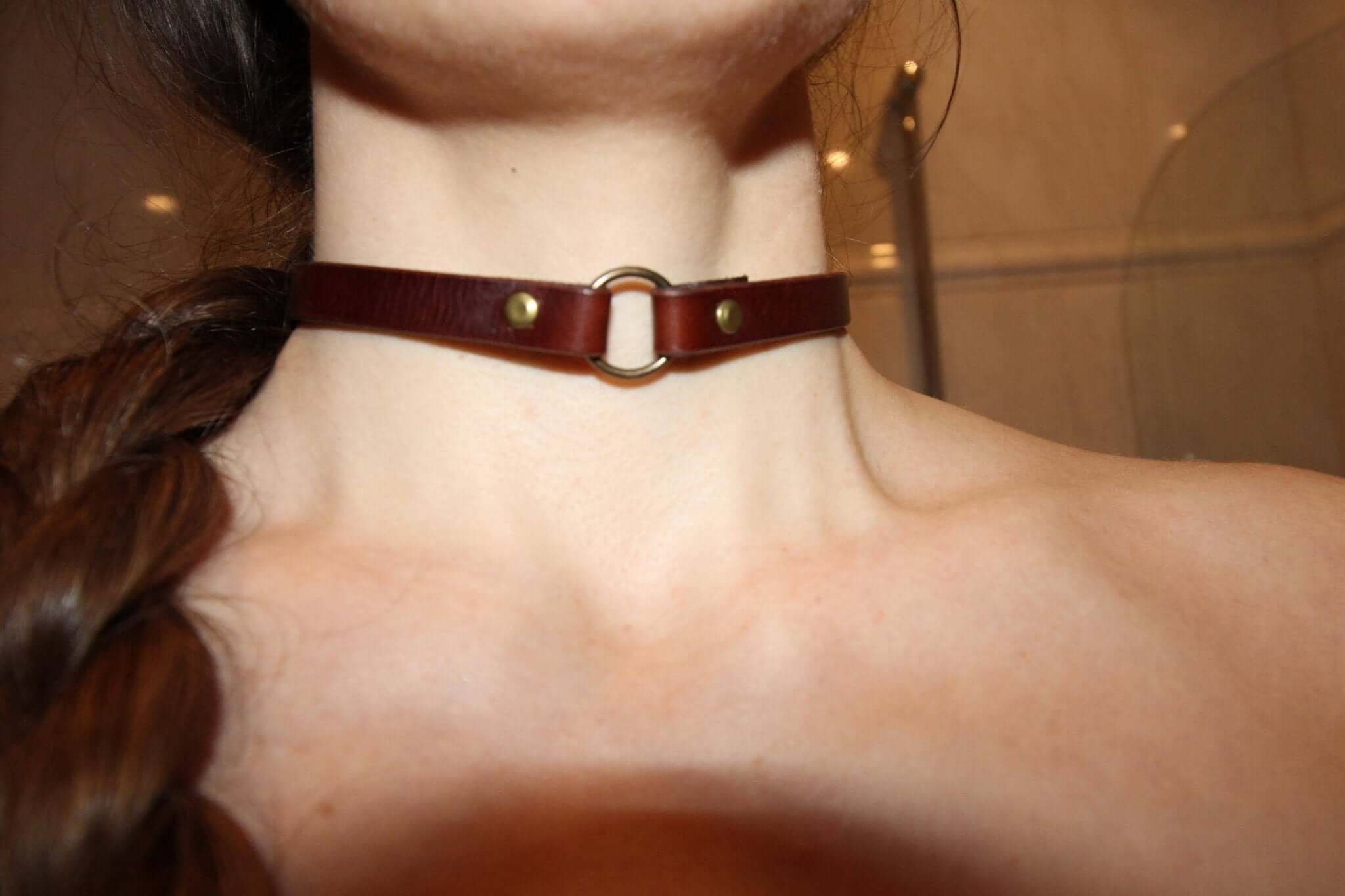 Handcrafted leather O-ring choker for alternative fashion, perfect submissive collar accessory for BDSM and edgy aesthetics.