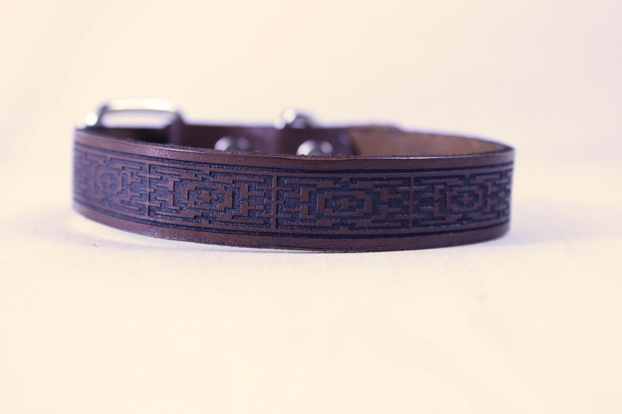 Handcrafted leather sub collar with intricate geometric pattern, perfect for BDSM and submissive jewelry.