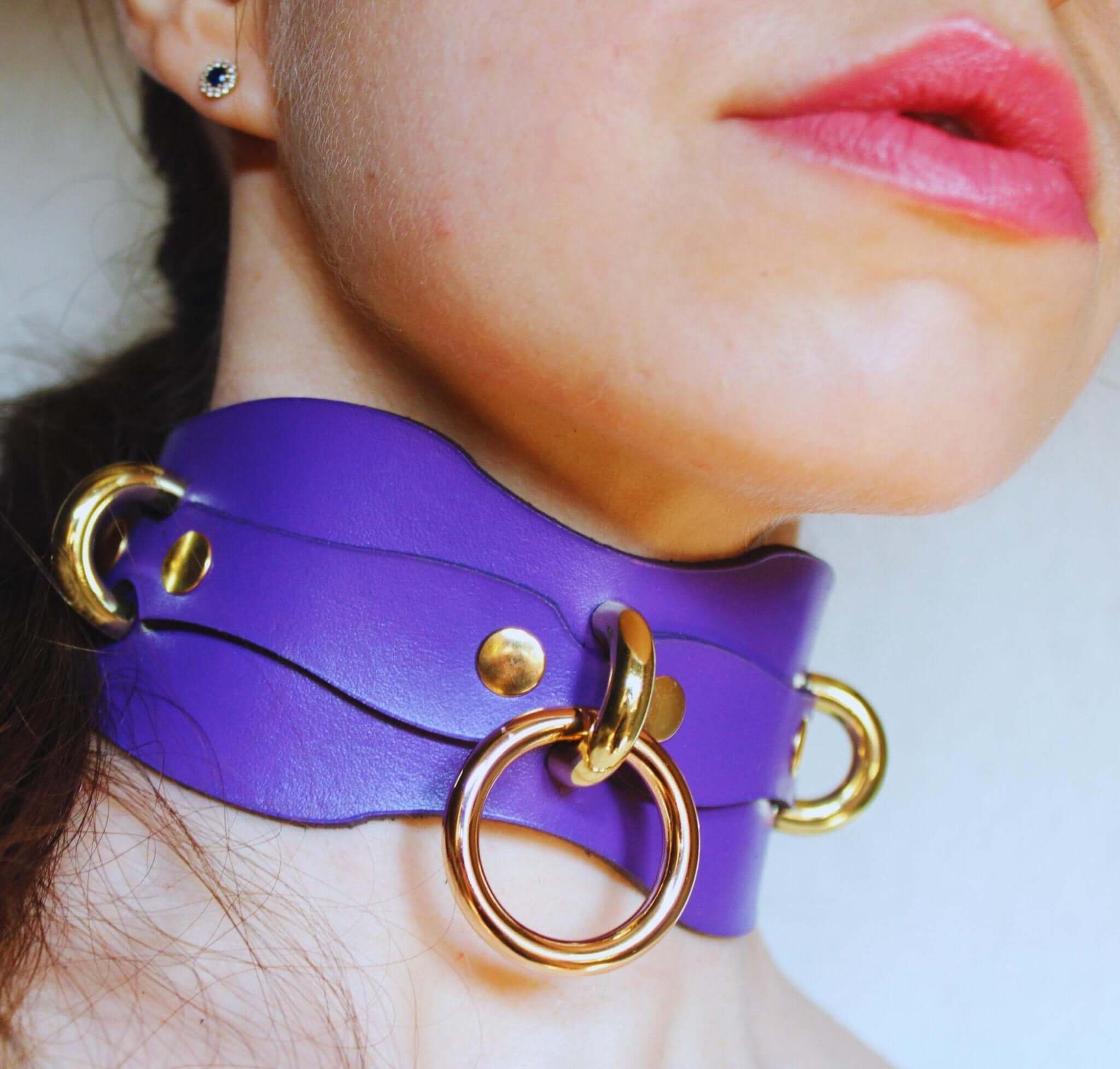 Handcrafted purple leather BDSM collar with gold hardware, perfect for submissive jewelry and bondage accessories.