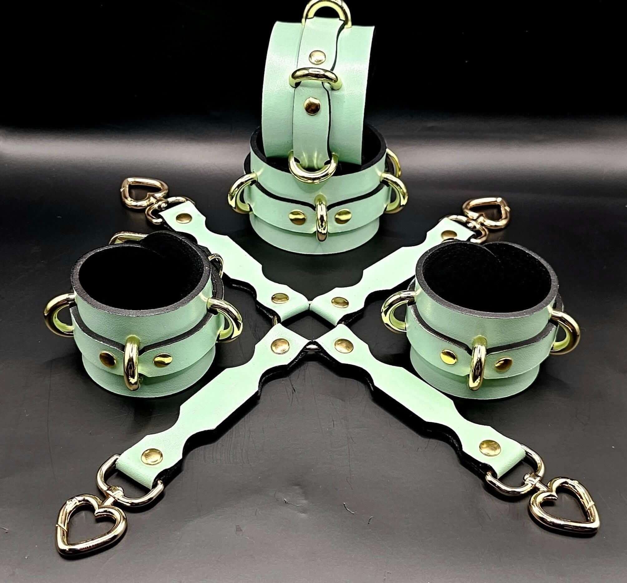 Handmade mint green leather cuffs and connector for BDSM play, ideal for wrist or ankle restraint, adjustable and comfortable.