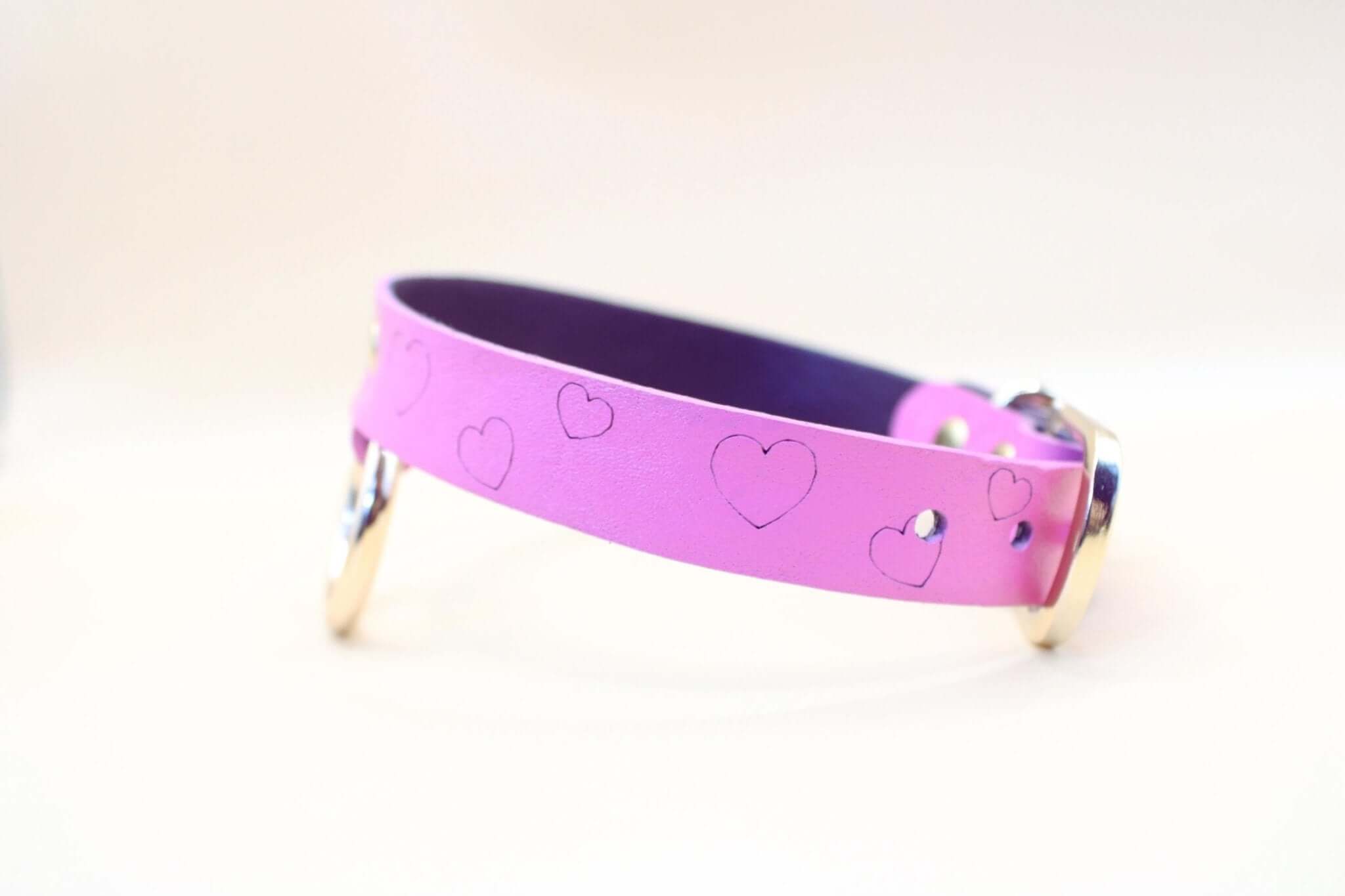 Heart print BDSM collar in pink leather, perfect for submissive jewelry and playful power exchange.