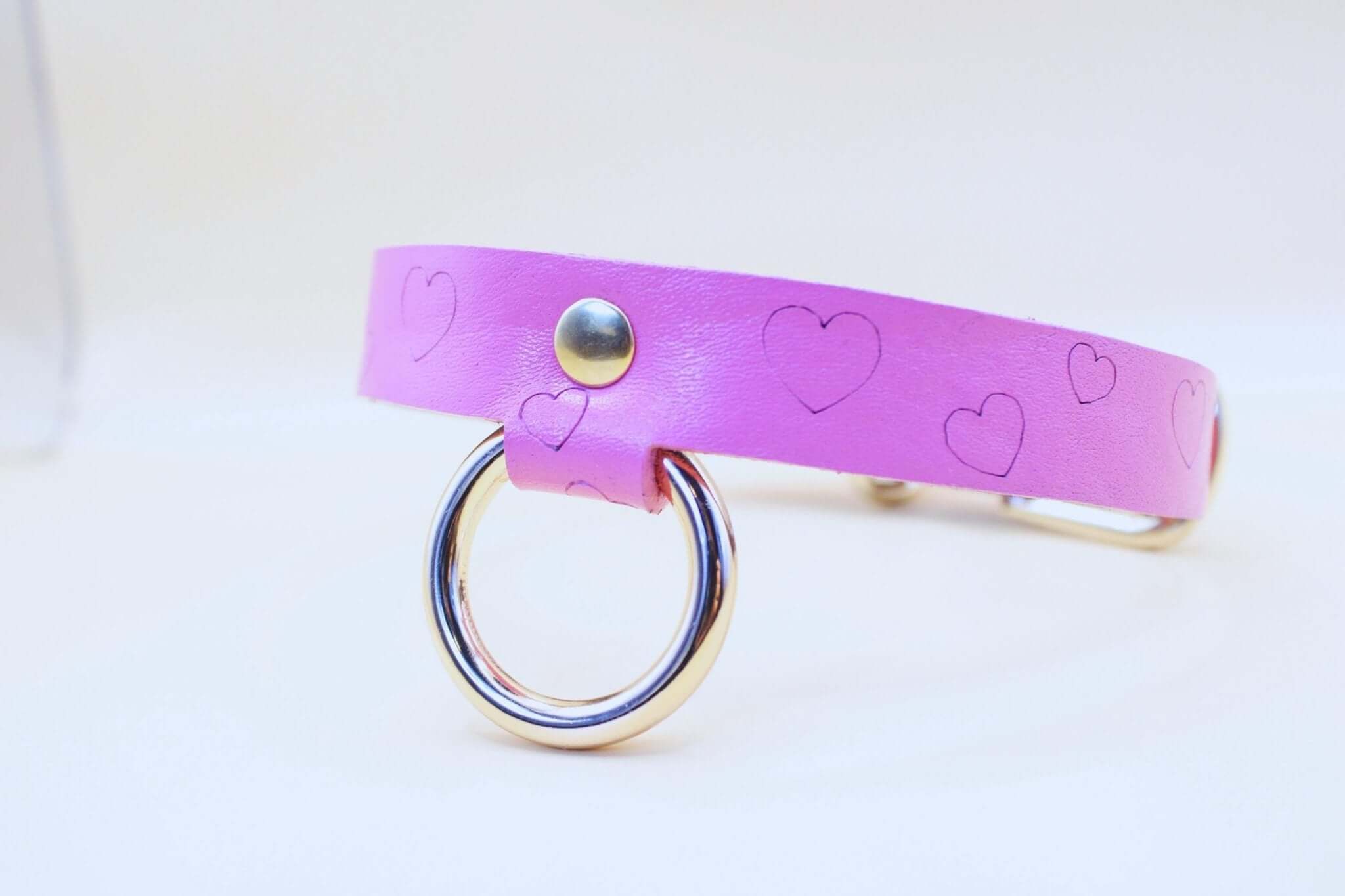 Pink heart print leather BDSM collar with metal ring, ideal for submissive jewelry and bondage gear.