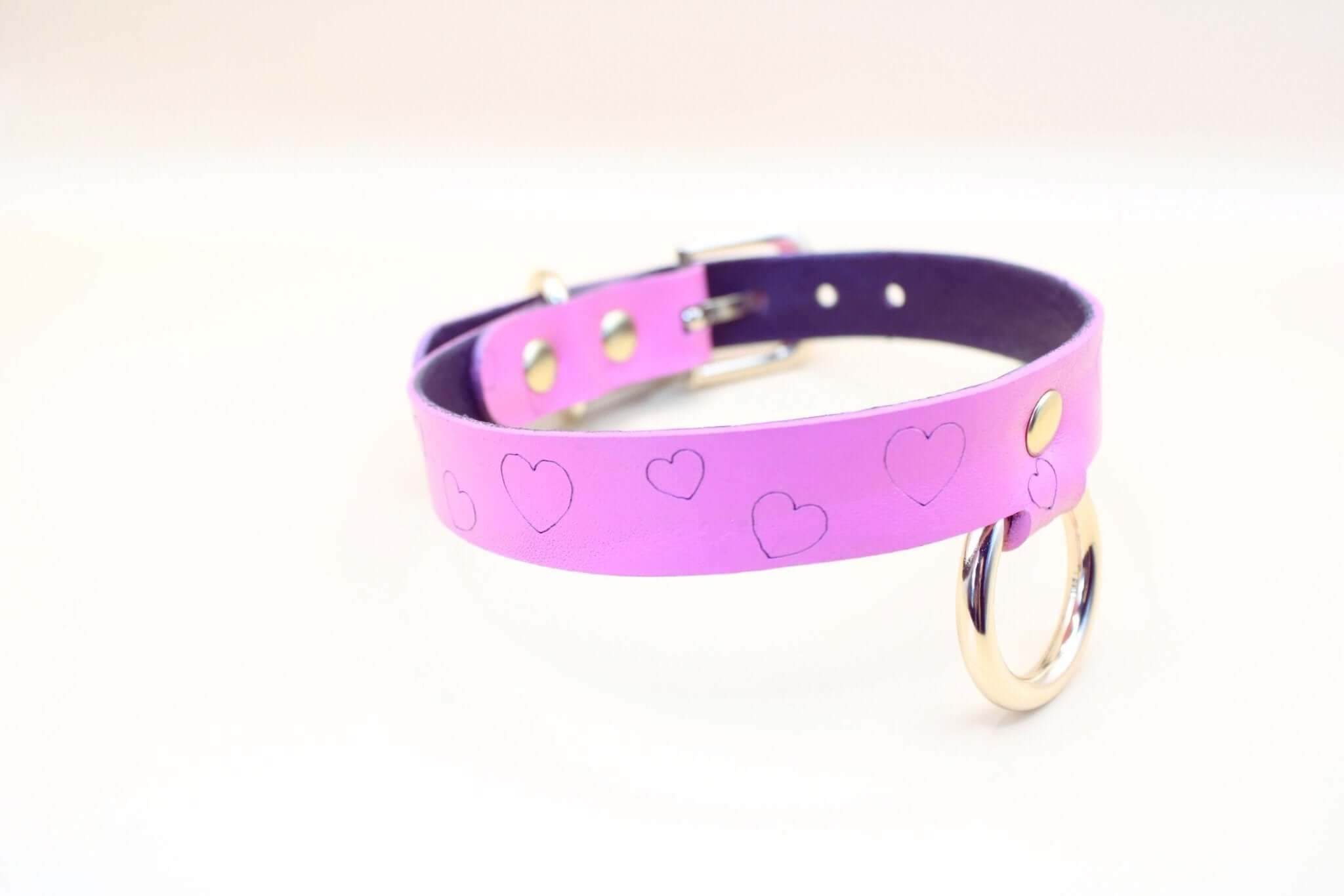 Heart print BDSM collar in pink leather, ideal for submissive jewelry and playful power exchange.