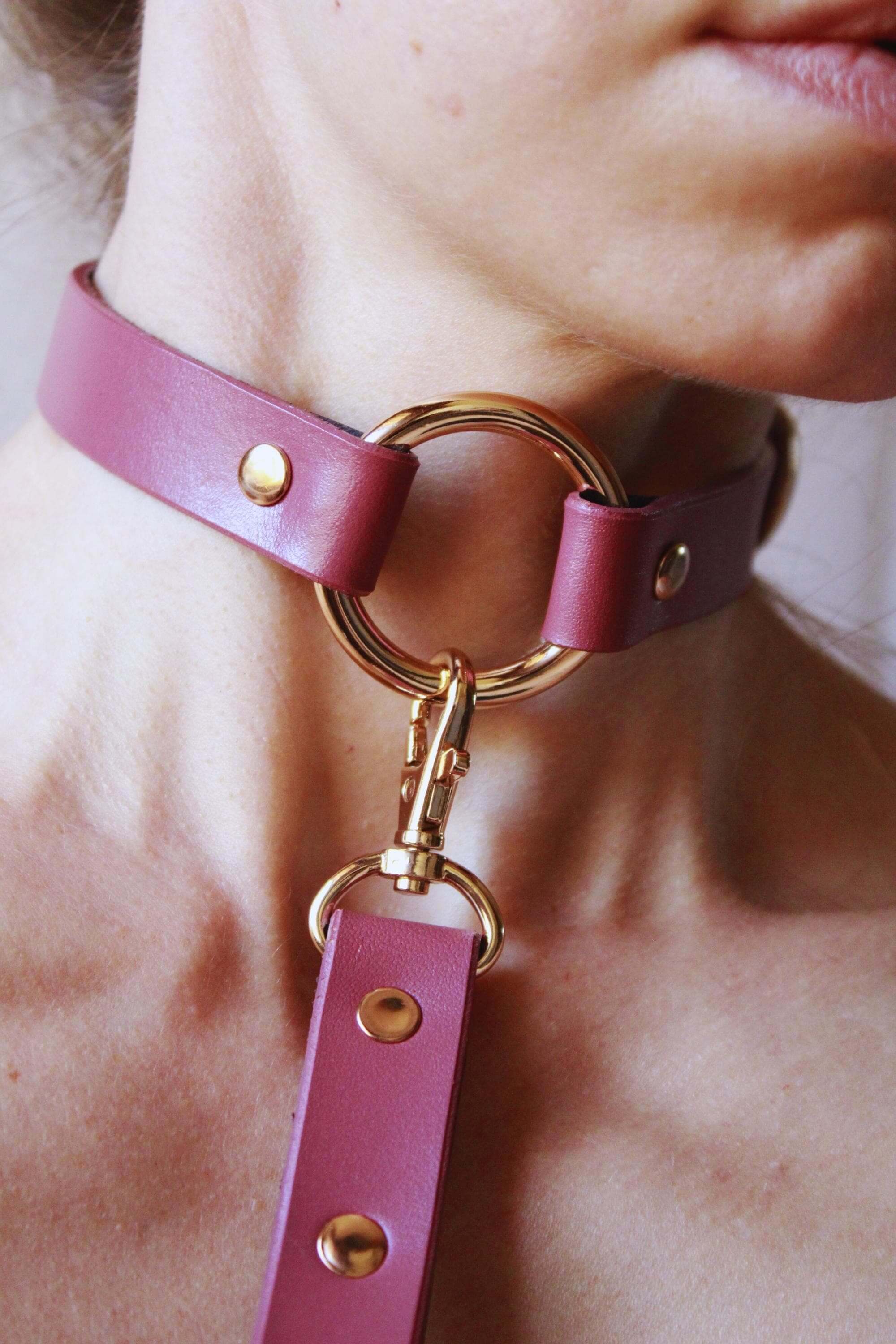 Discreet day collar leather choker in soft pink, an elegant submissive jewelry piece for everyday wear.