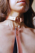 Submissive jewelry featuring a Pearl Rose O-Ring choker collar, crafted from vegan leather for discreet BDSM fashion.
