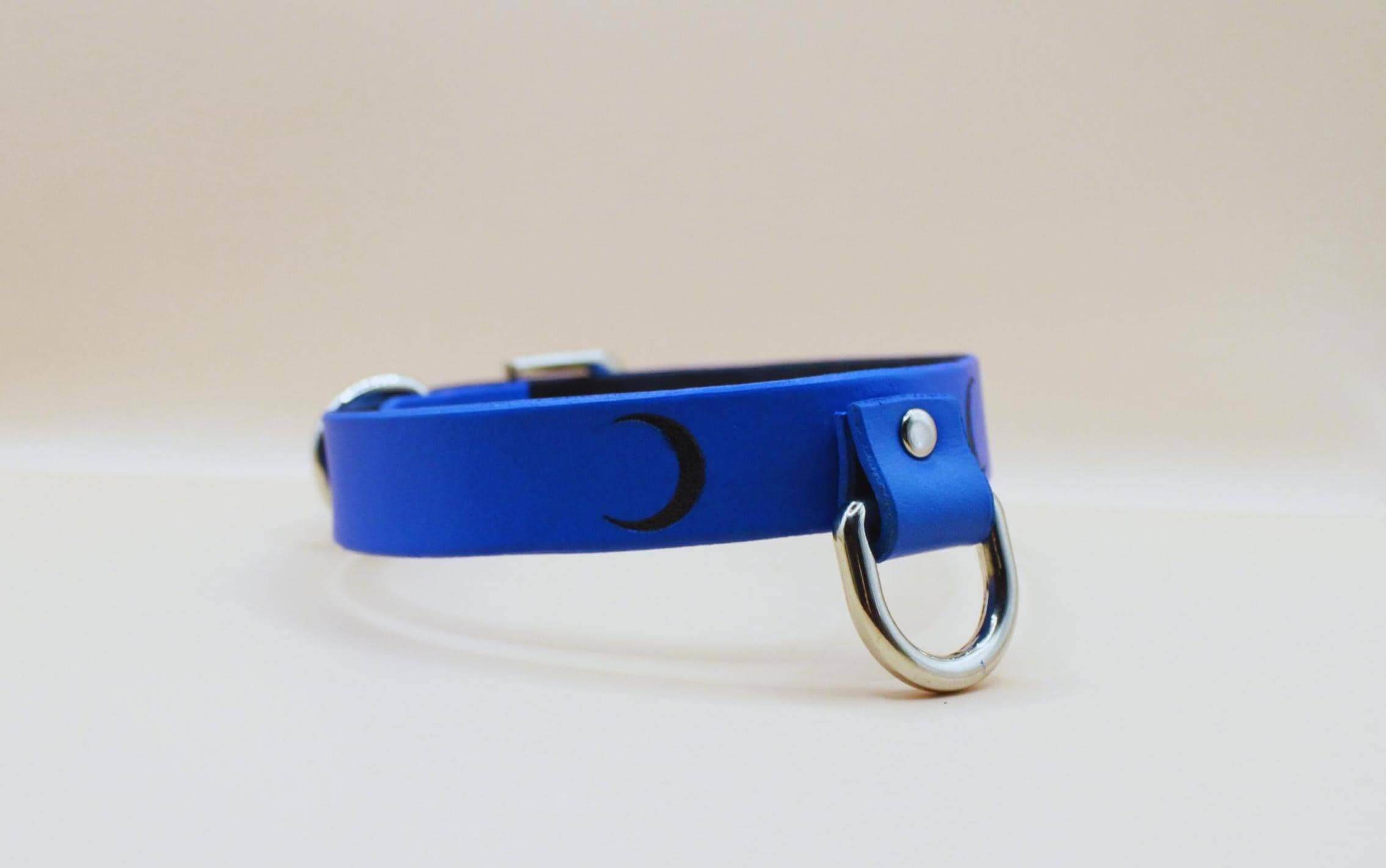 Blue leather BDSM collar with crescent moon design, perfect for submissive jewelry and discreet day wear.