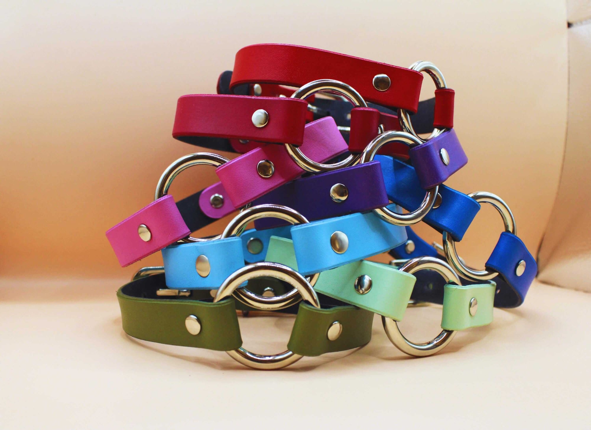 Colorful vegan leather BDSM collars with O-rings, ideal for submissive jewelry and discreet day collar fashion.