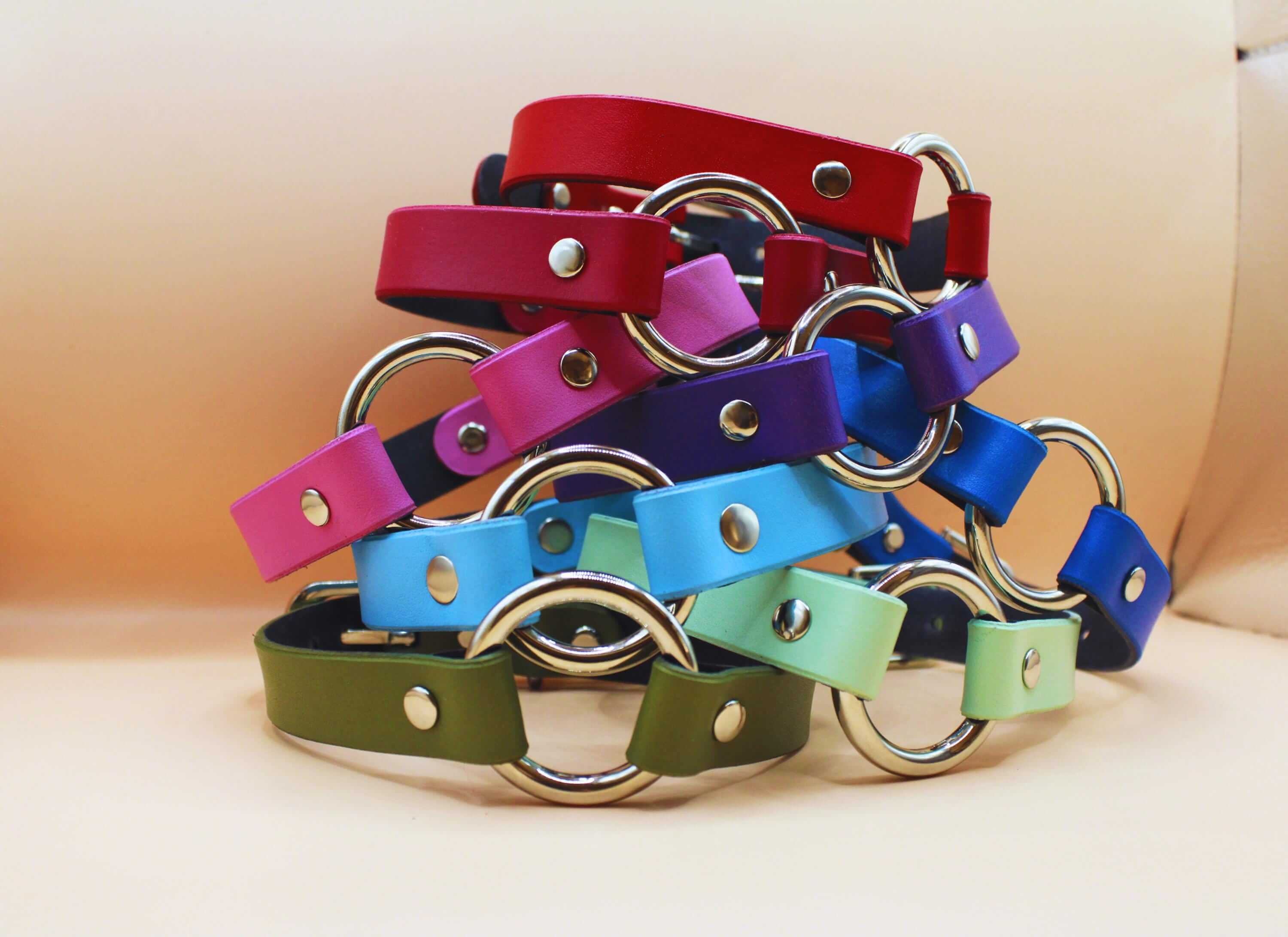 Colorful BDSM collars in various shades, featuring metal rings for bondage and submissive jewelry, perfect for dom sub gifts.