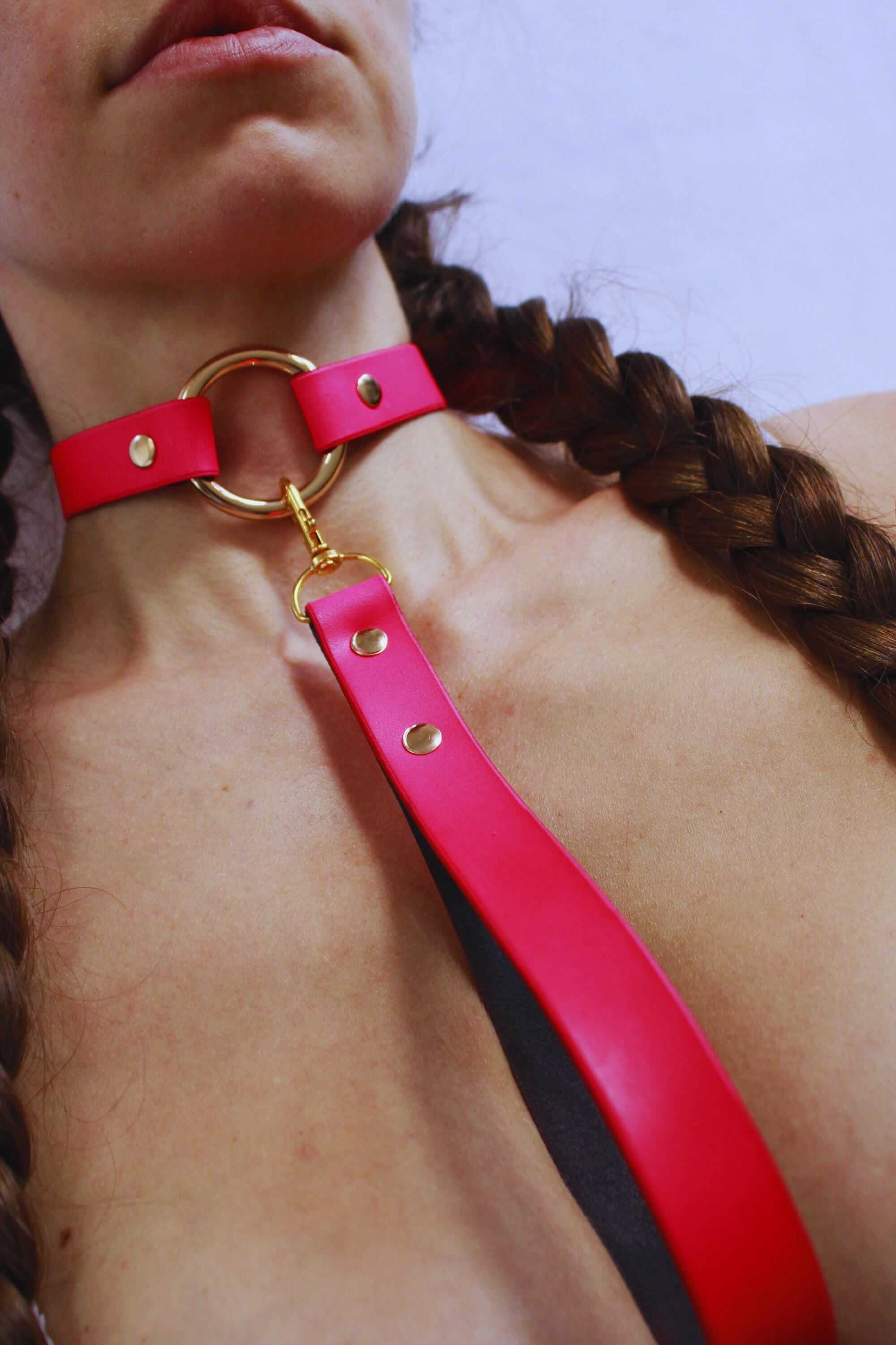 Bdsm collar in Rio Red, a striking submissive necklace with gold accents, perfect for discreet day wear and intimate play.