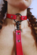 Close-up of a pearl red BDSM leather collar showcasing its sleek design, perfect for discreet day wear and bondage experiences.