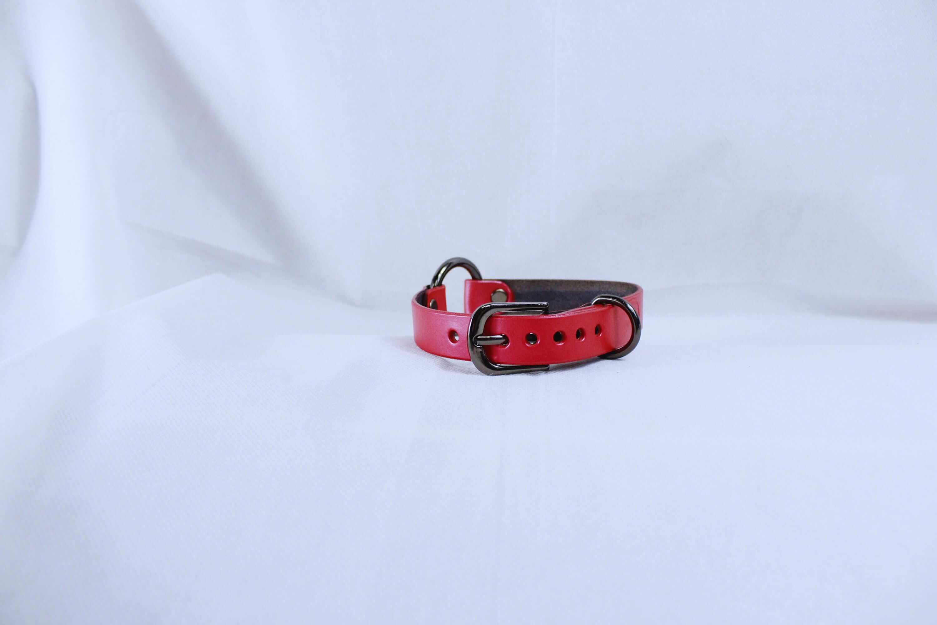 Pearl red leather BDSM collar with metal buckles, perfect for a discreet day collar or submissive jewelry.