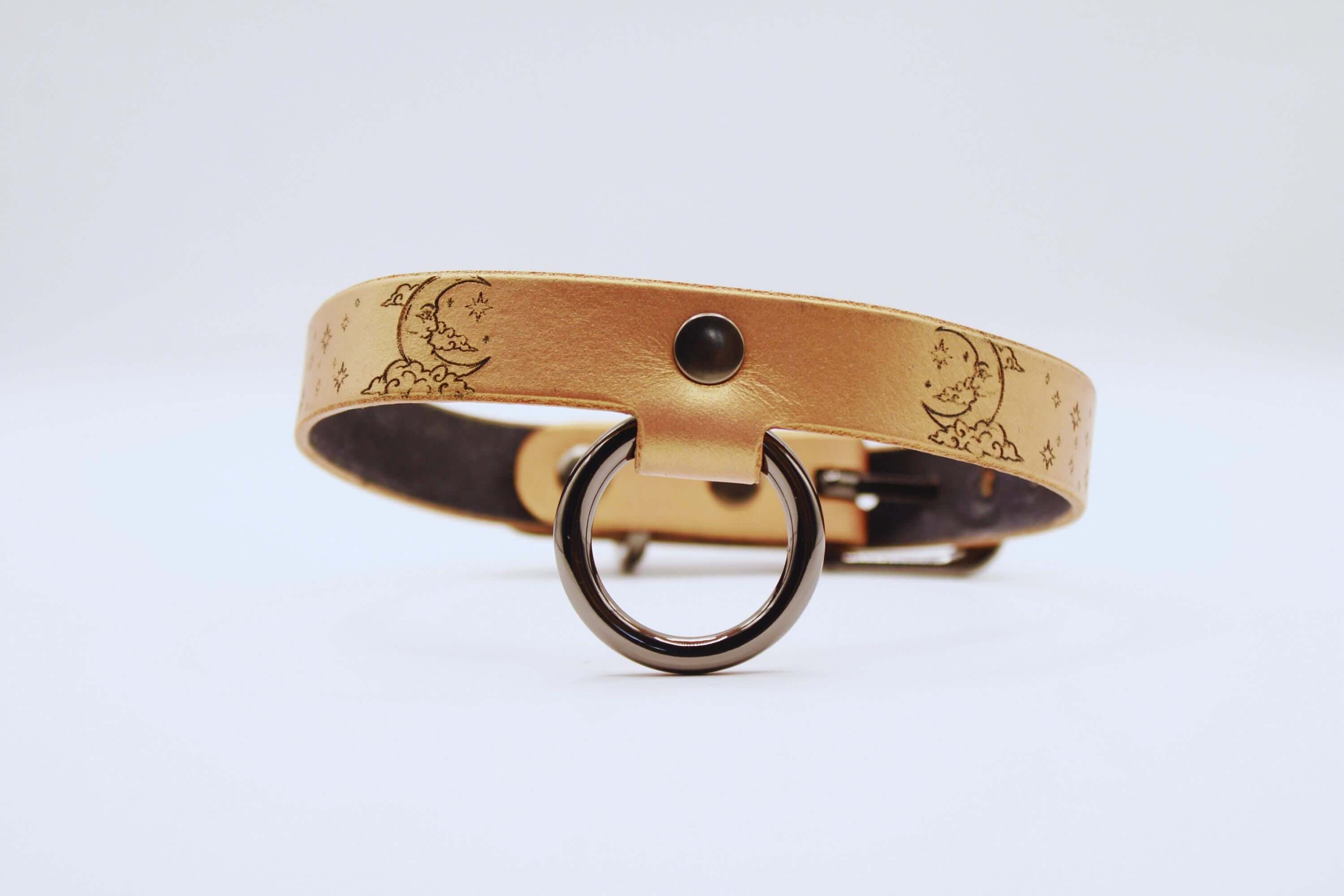 Elegant leather choker with moon and stars, minimalist statement necklace in soft tan tone.