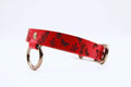 Discreet day collar handmade in red leather, featuring butterfly and sun designs. Ideal submissive collar for BDSM enthusiasts.