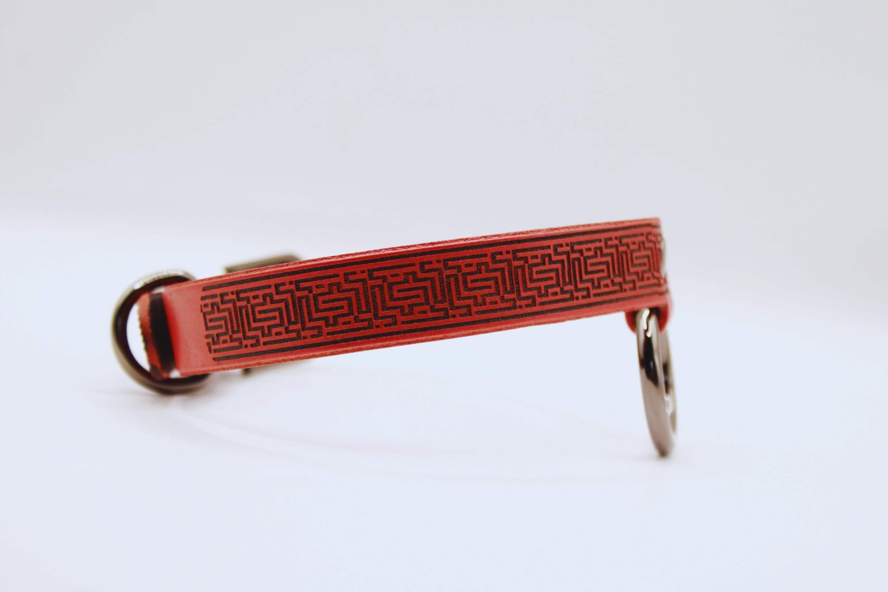 Elegant red leather submissive collar with a decorative pattern, perfect for BDSM enthusiasts.