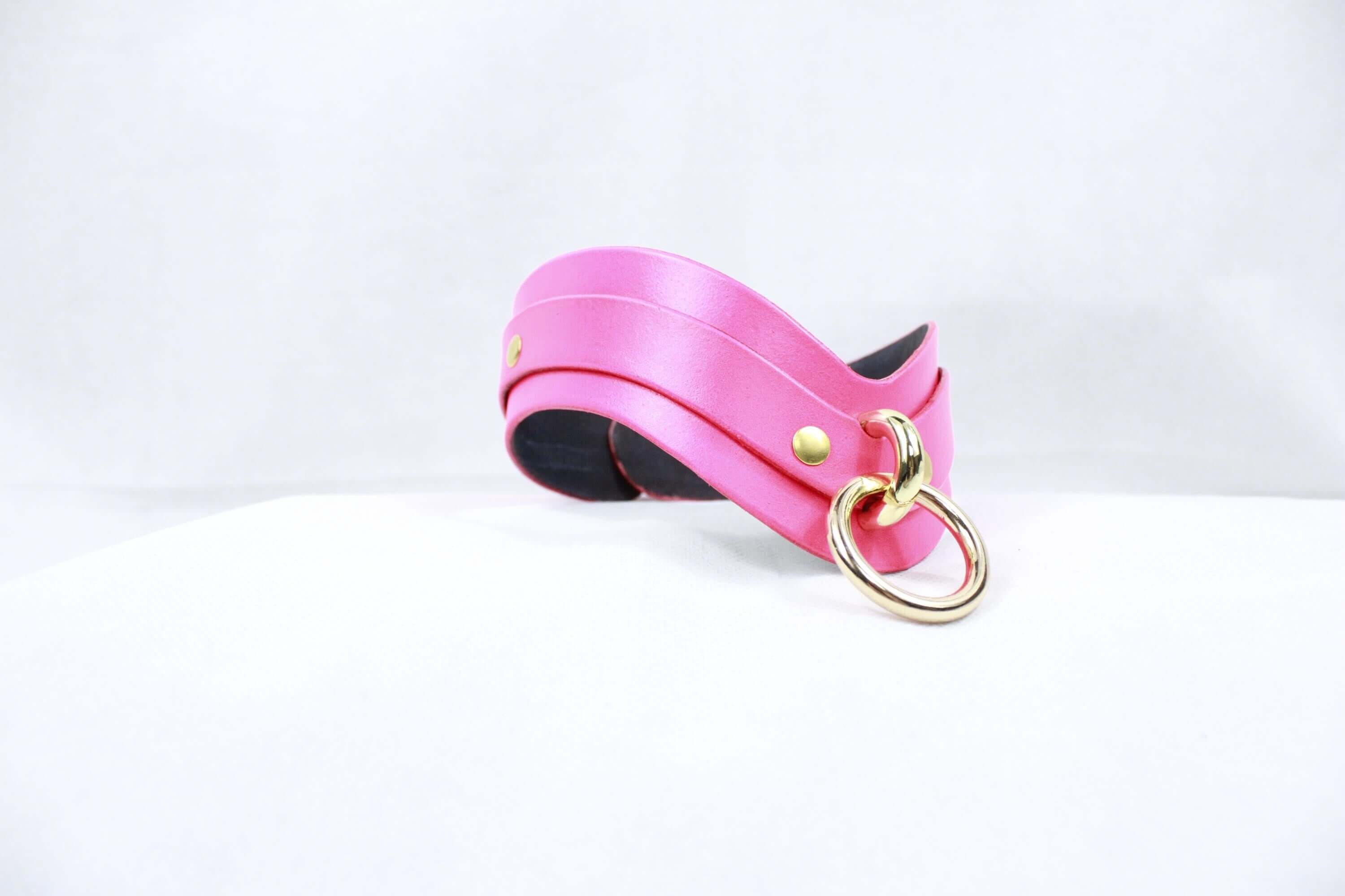 Elegant pink leather BDSM collar with gold ring, perfect as a discreet day collar for submissive wear.