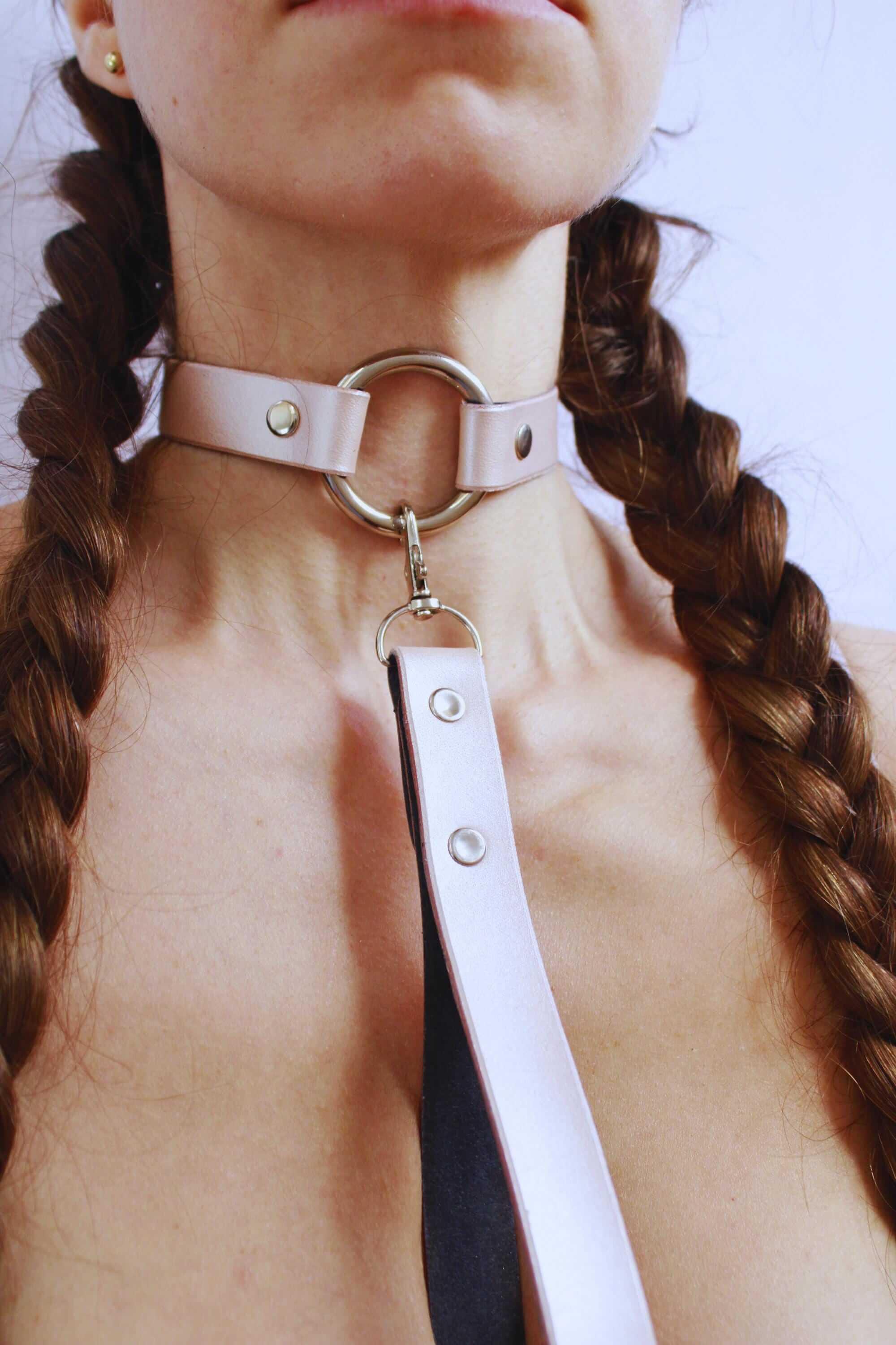 Pearl silver leather choker worn as a stylish submissive collar, perfect for discreet daywear and bondage jewelry.
