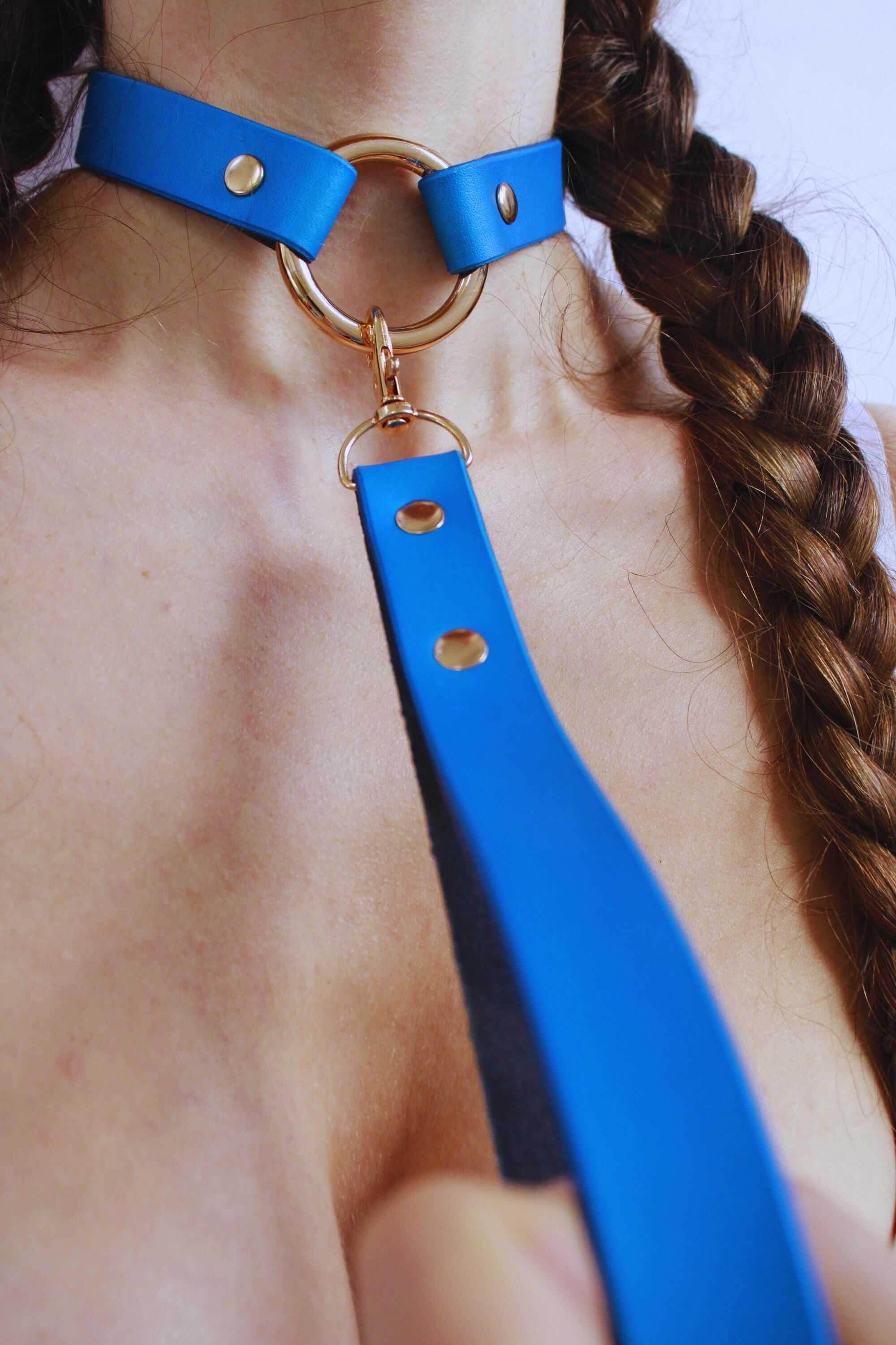 Pearl blue leather submissive collar featuring a gold ring, perfect for BDSM day wear and discreet submissive jewelry.