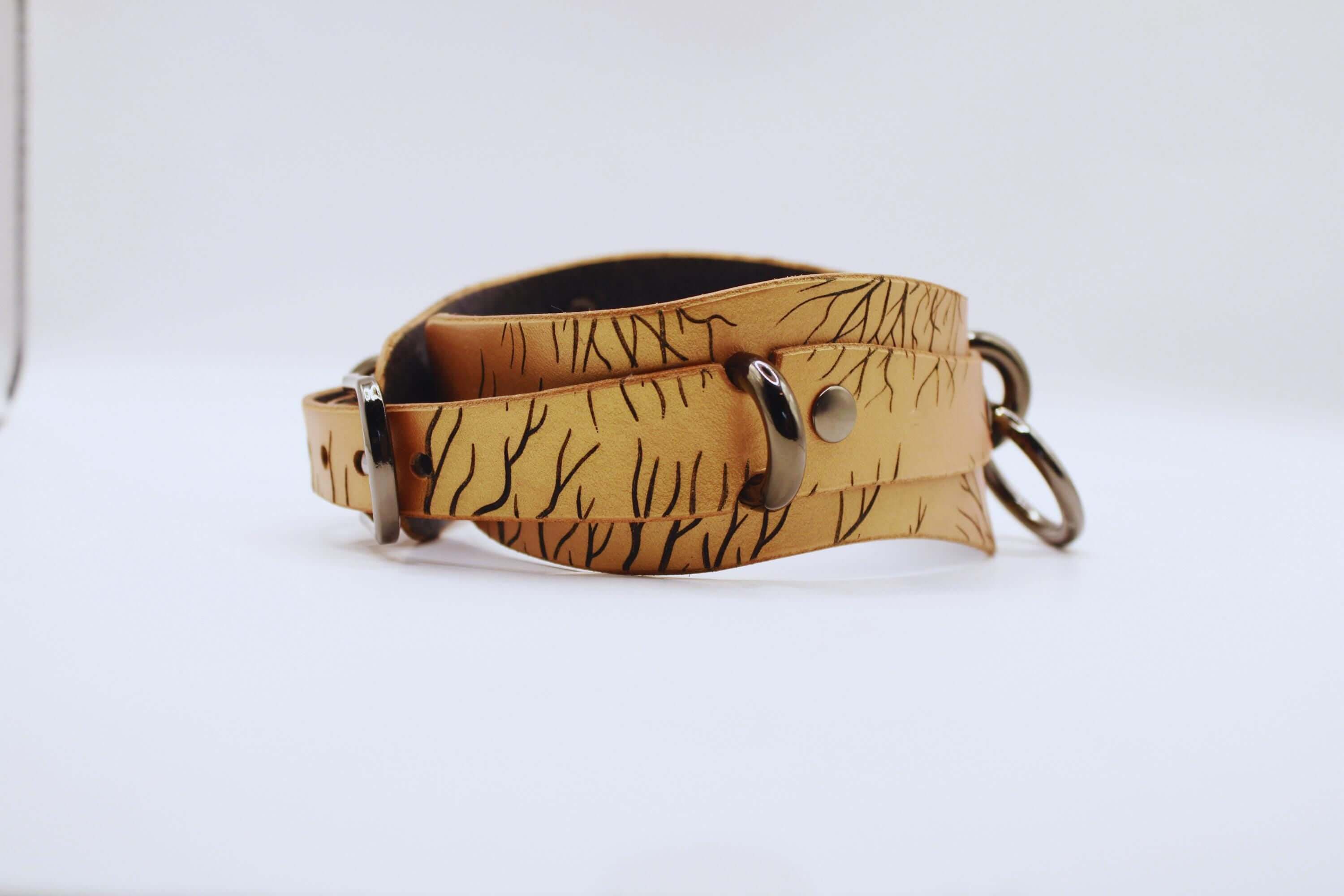 Handcrafted submissive collar made from genuine leather, featuring a nature-inspired pattern. Ideal as a discreet day collar.