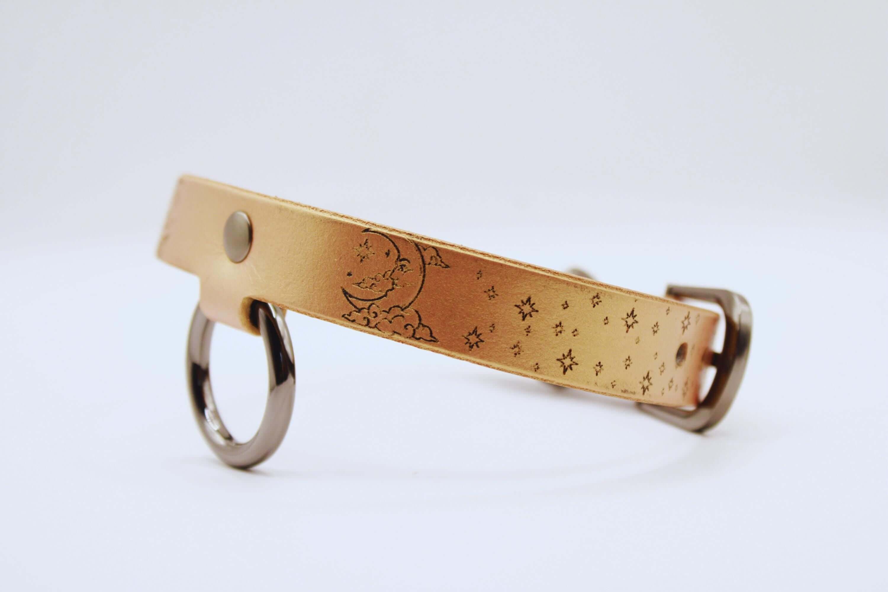 Elegant leather choker with moon and stars design, perfect minimalist statement necklace for everyday wear.