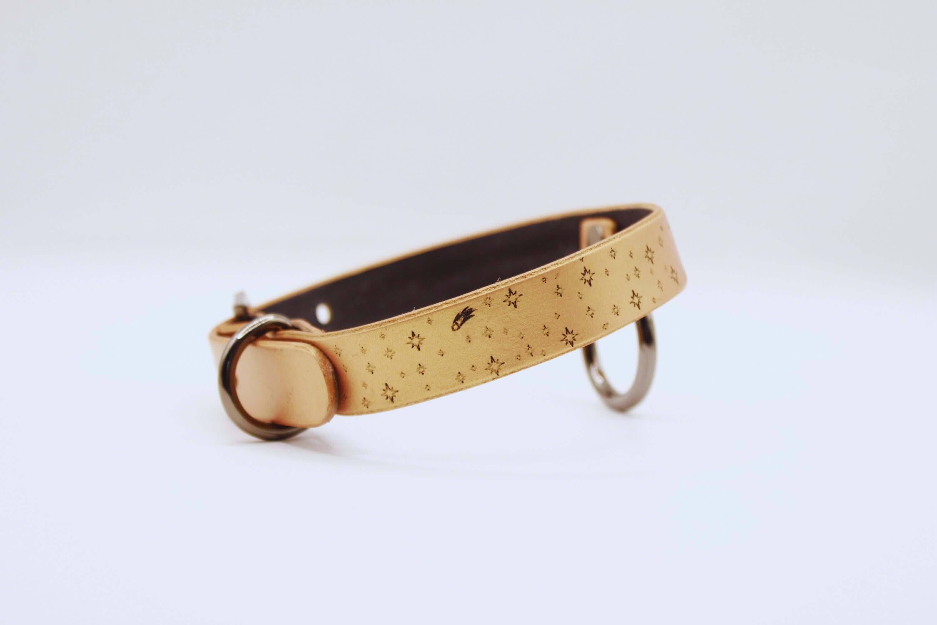 Elegant leather choker in soft tan with laser-etched moon and stars, perfect minimalist statement necklace.