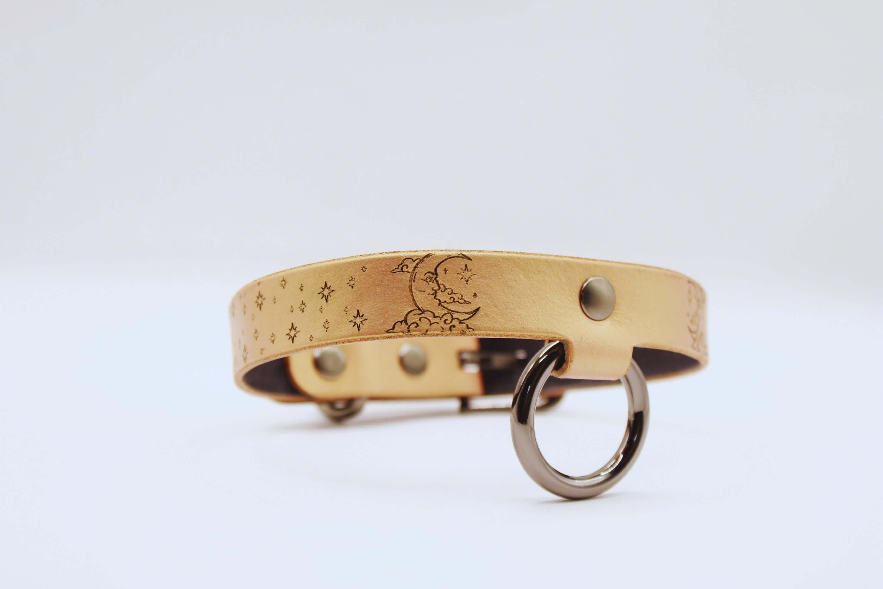 Elegant leather choker with moon and stars design, perfect minimalist statement necklace.