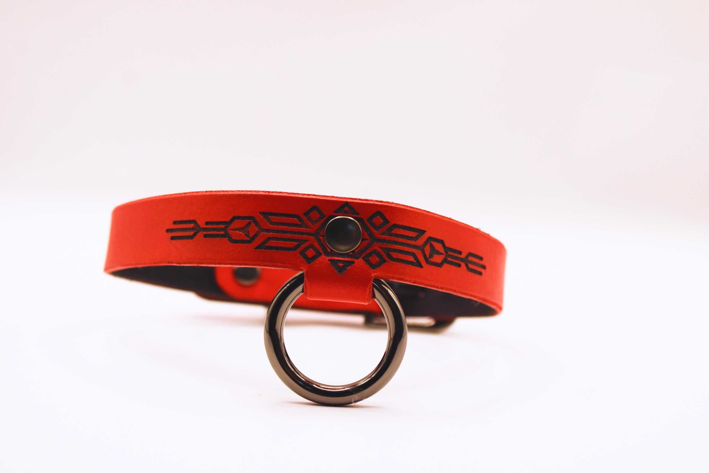 Submissive collar of fire, red leather BDSM collar with black geometric patterns for discreet day wear.