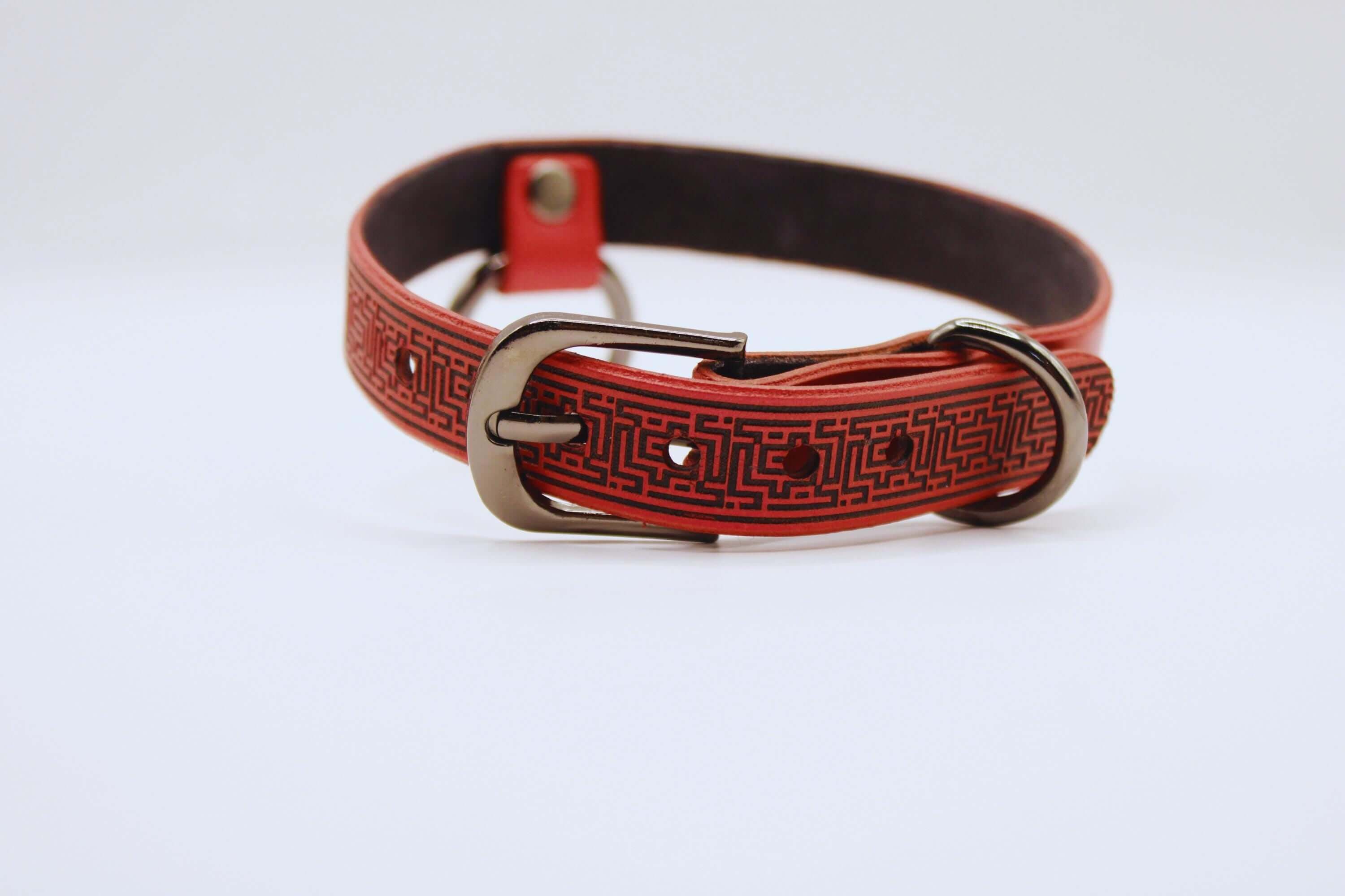 Red leather BDSM collar with intricate design for submissive style and elegance.
