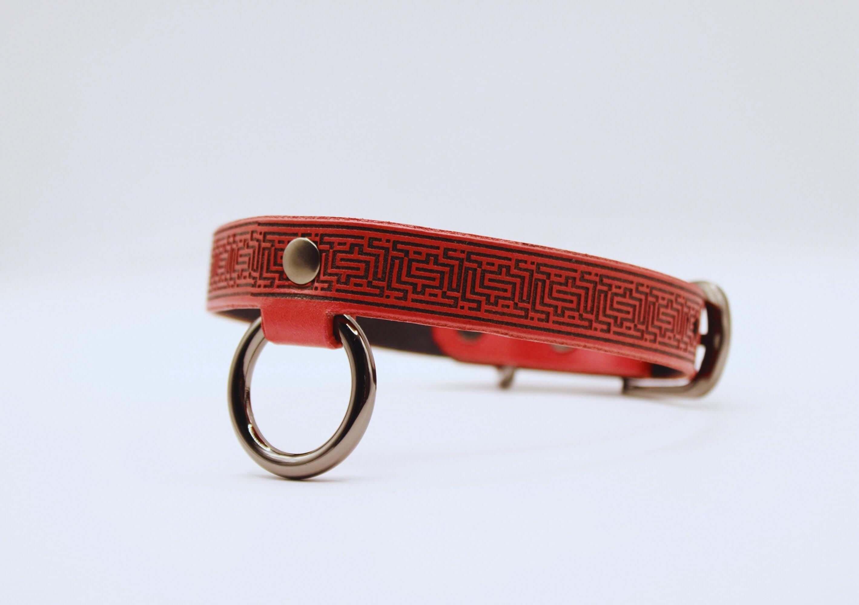 Red leather BDSM collar featuring intricate design, perfect for submissive styles and daily wear.