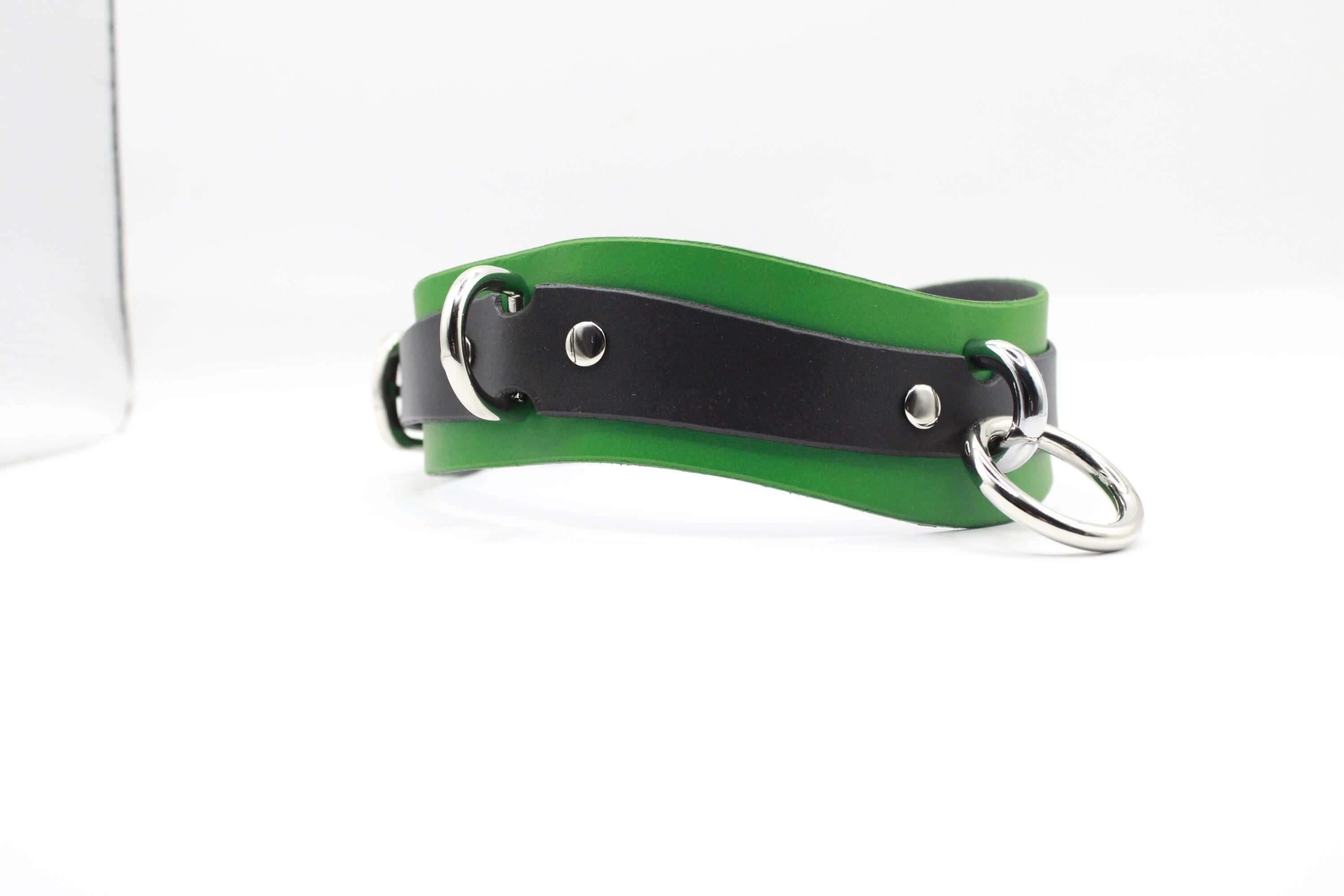 A green and black leather choker necklace with silver metal rings and buckles.