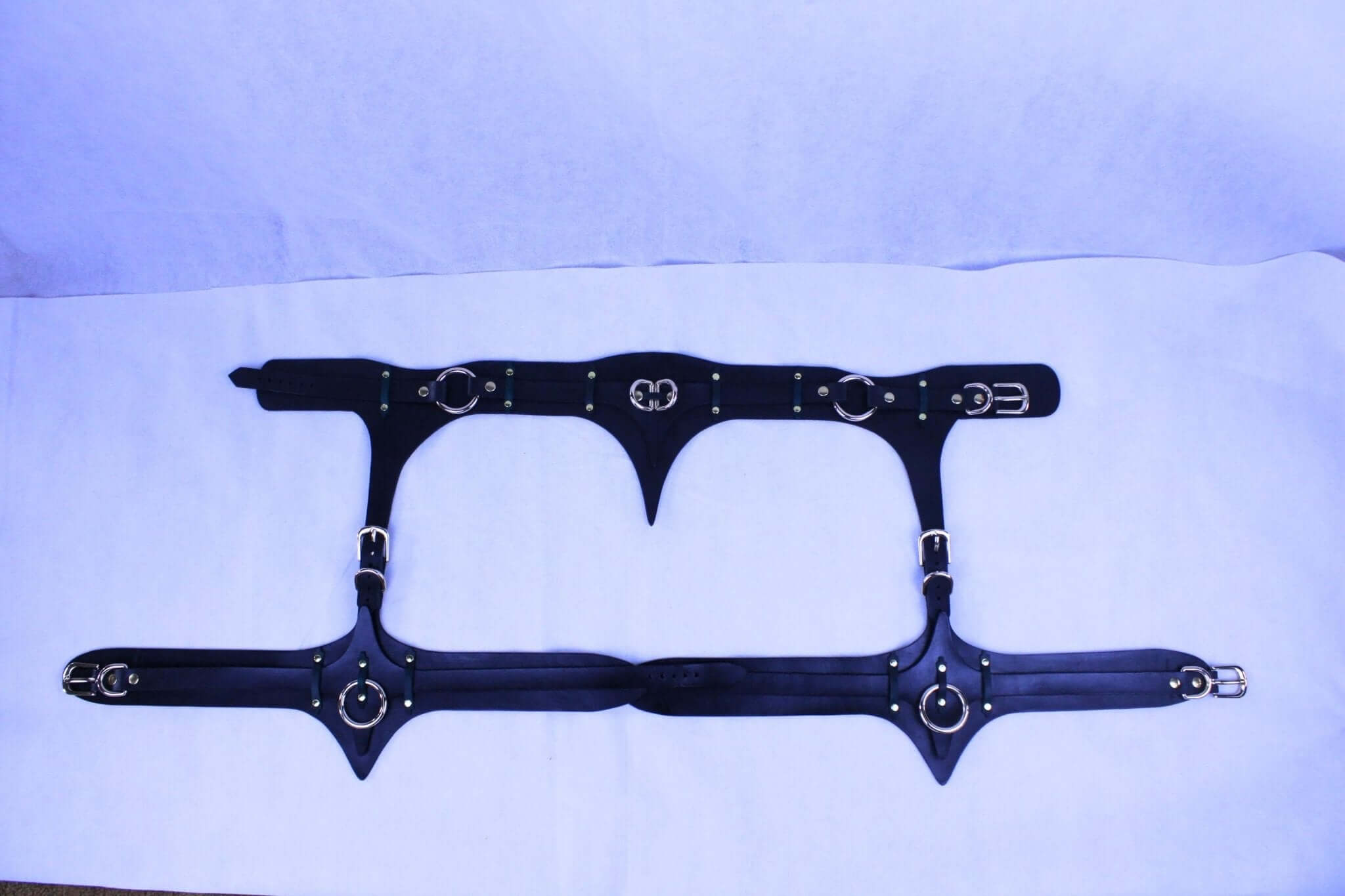 Italian leather thigh harness set showcasing adjustable buckle details, perfect for bondage and erotic lingerie.