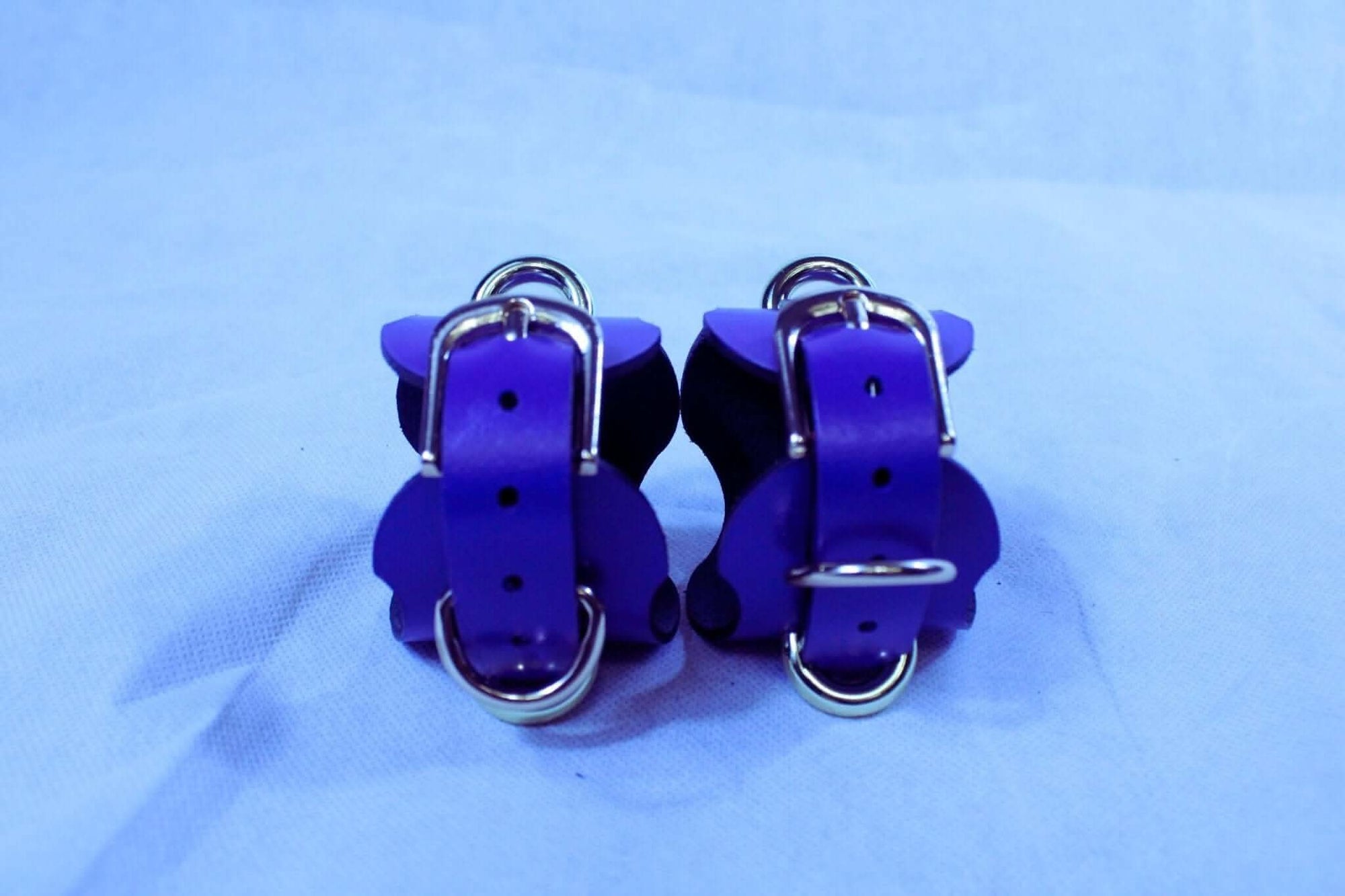 Purple handmade leather ankle cuffs for bondage, adjustable and secure for submission and restraint in D/s lifestyle.