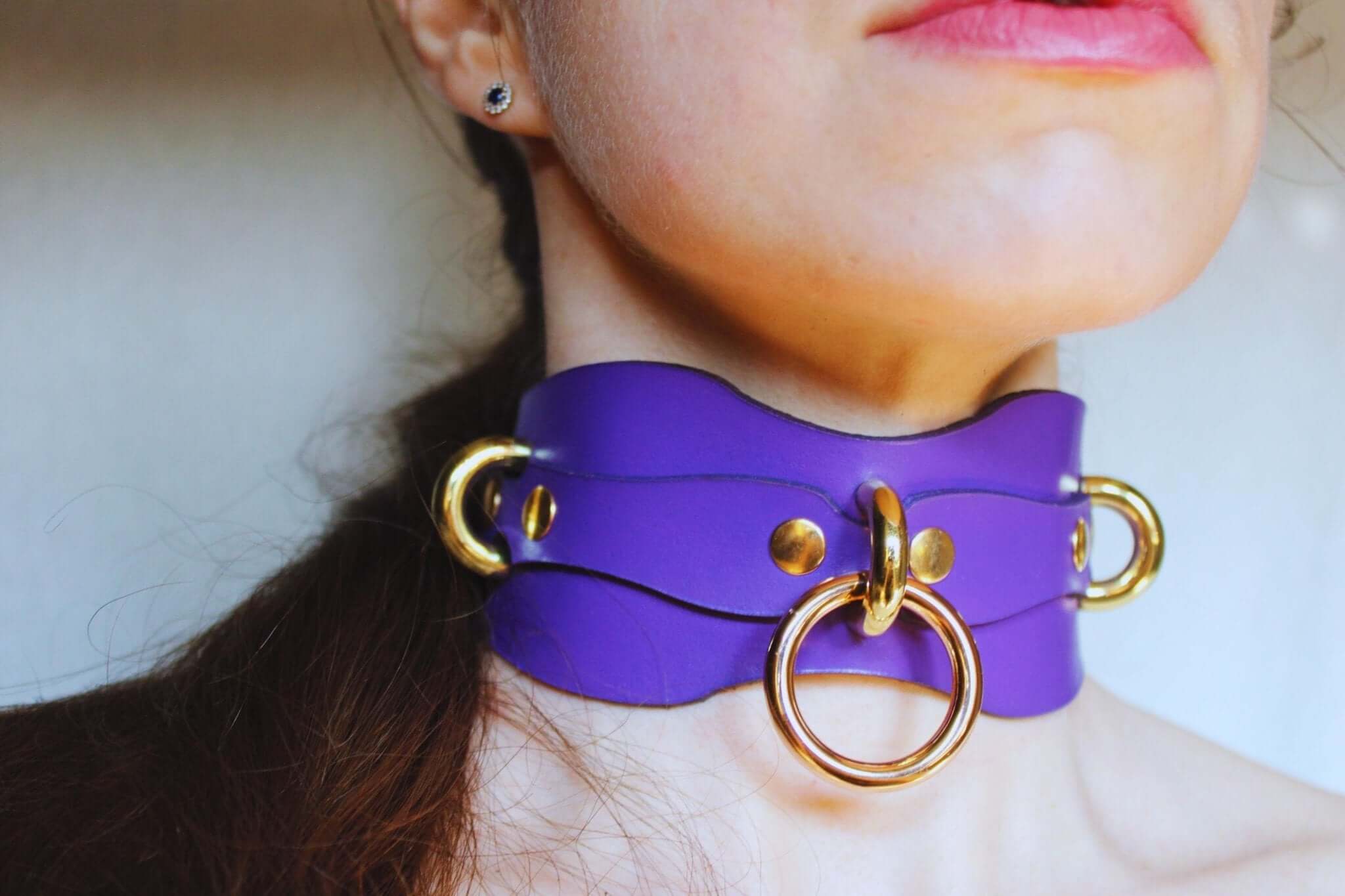 Purple leather BDSM collar with O-ring, perfect for submissive play and as a stylish bondage accessory.