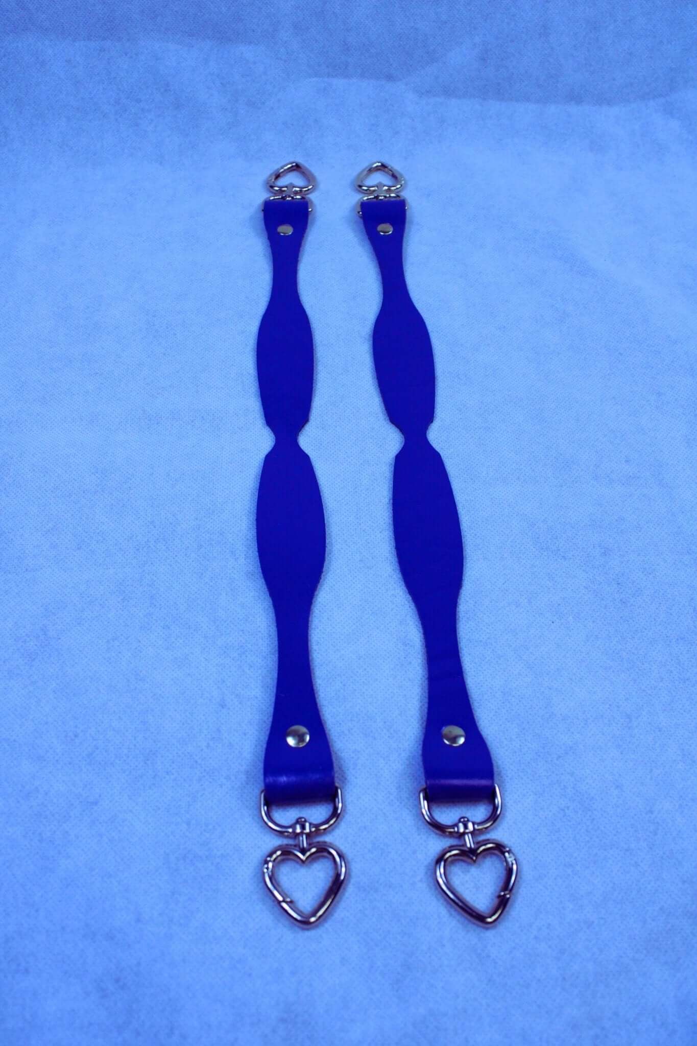 Handmade blue leather connectors with heart D-ring attachments, perfect for BDSM gear and bondage accessories.