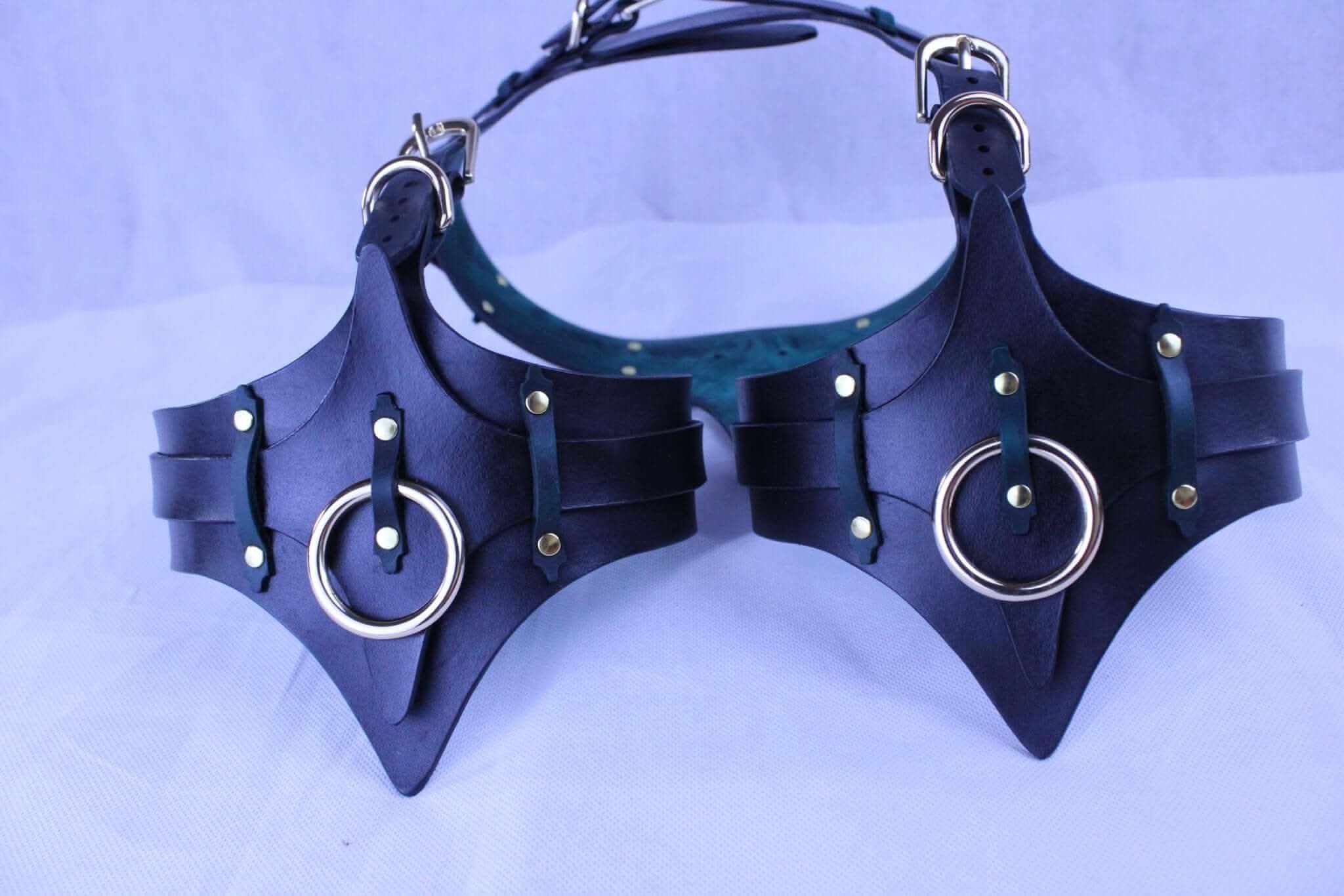 Leather bondage harness with thigh cuffs and rings for erotic lingerie and BDSM gear.