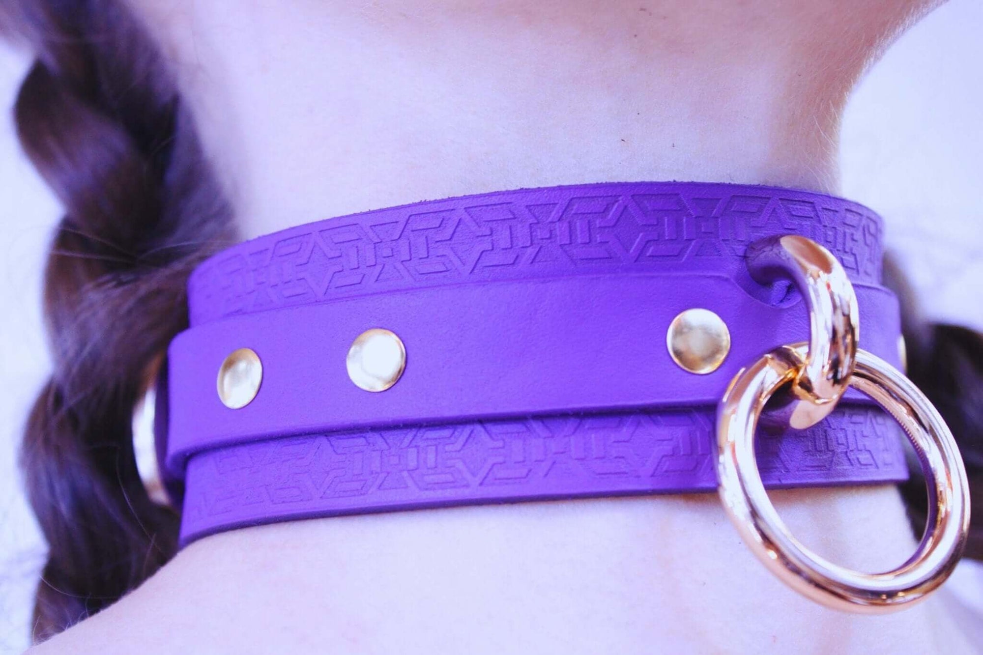 Vibrant violet leather choker collar with gold hardware, perfect for BDSM and discreet daily wear as a submissive accessory.